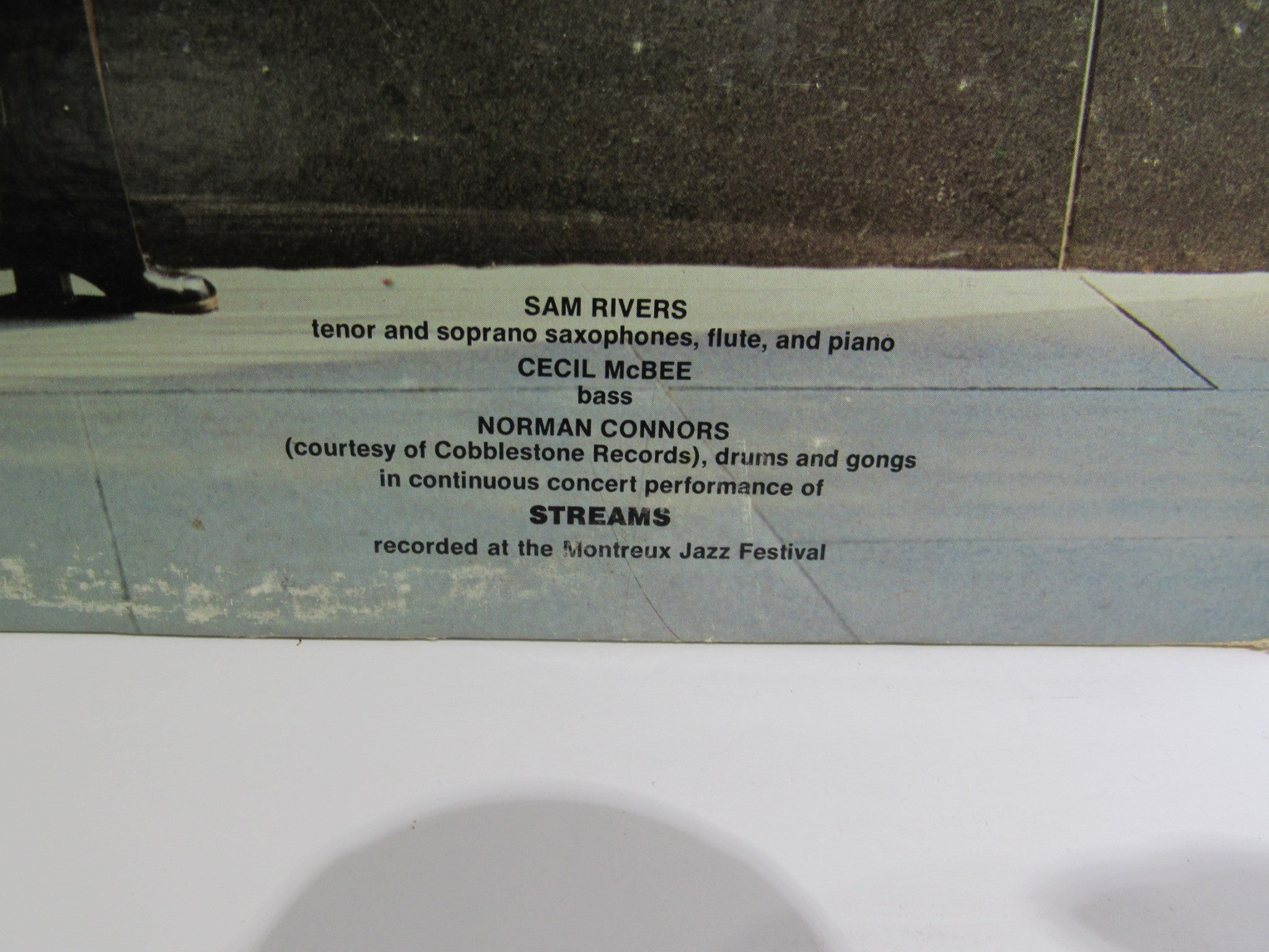 Detailed image of the back cover text of Sam Rivers: Streams Impulse! AS-9251 LP, listing the artists involved and the Montreux Jazz Festival recording.