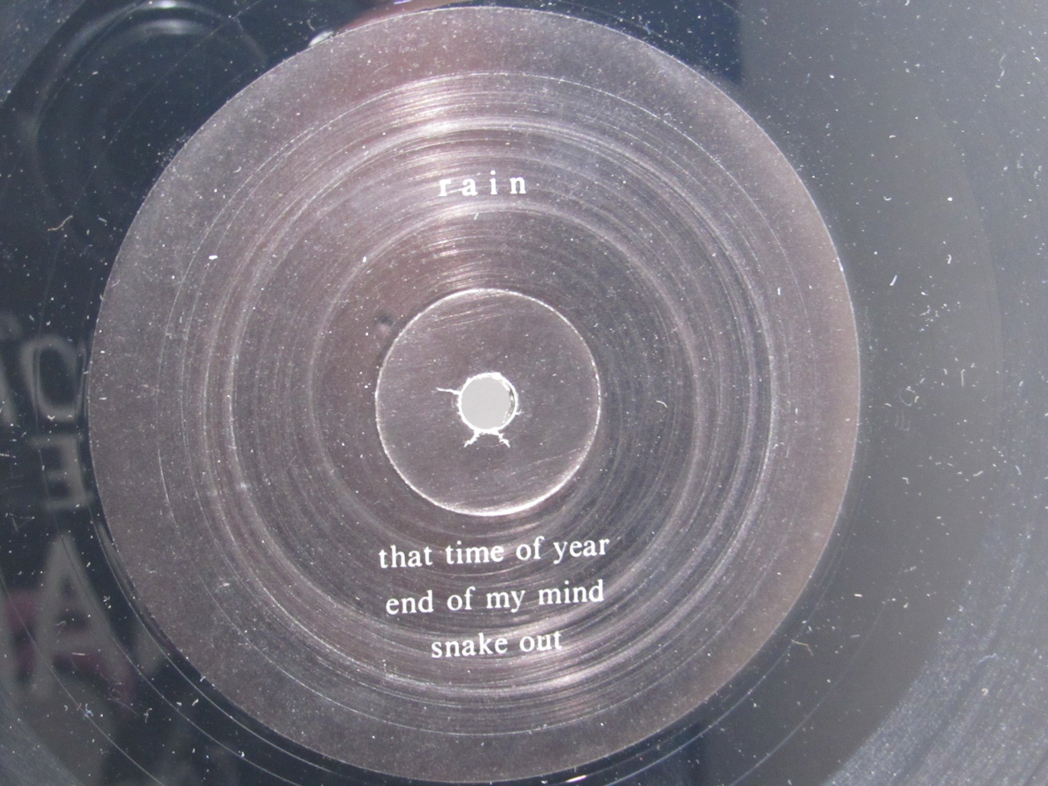 Vinyl record label of 'Rain La Vache Qui Rit Peterbilt Records Peterbilt 3 1990 Rock LP Grade: VG', featuring song titles like 'that time of year', 'end of my mind', and 'snake out'.
