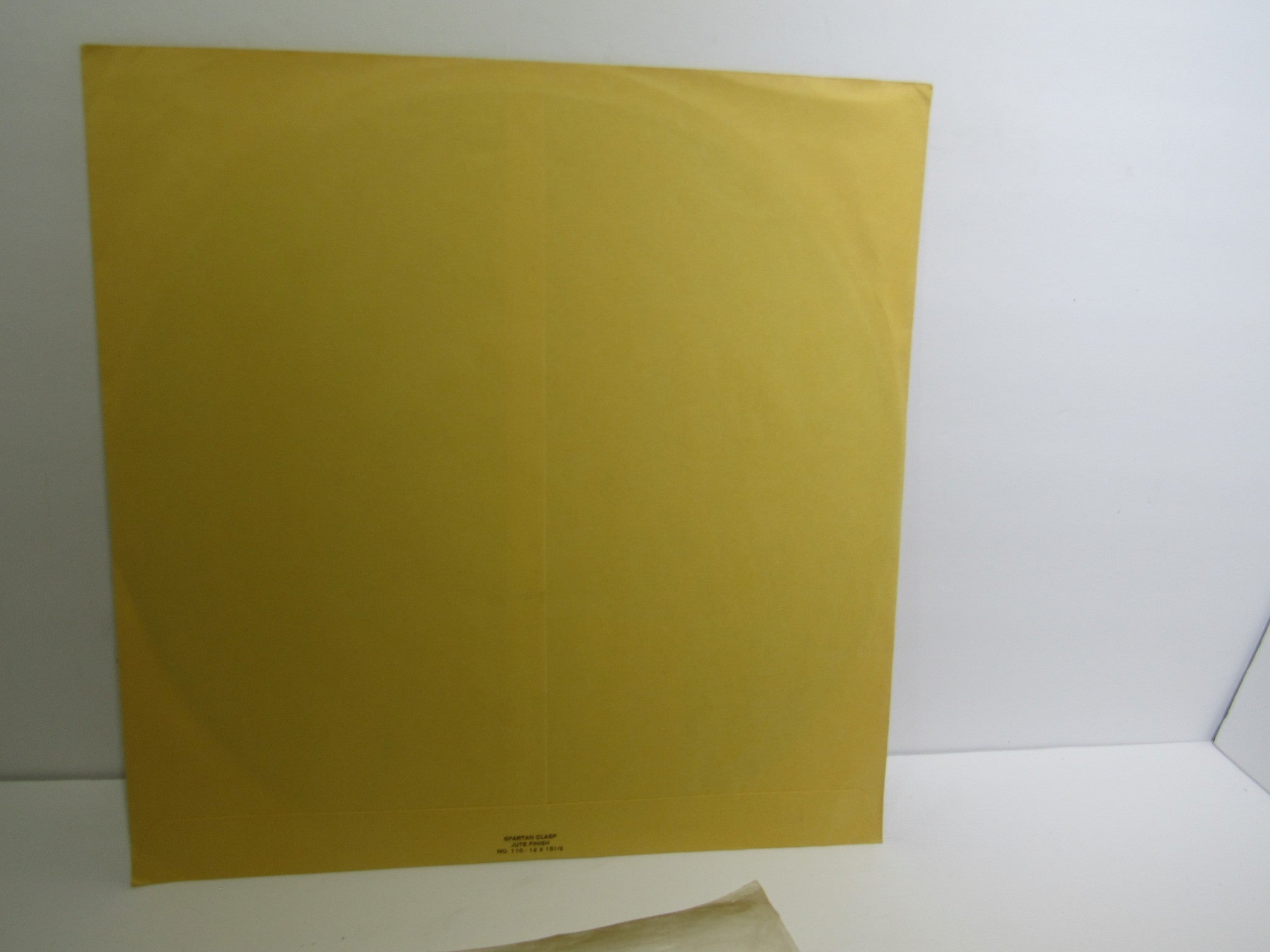 Back cover of 'Rain La Vache Qui Rit Peterbilt Records Peterbilt 3 1990 Rock LP Grade: VG', showcasing a plain yellow design.