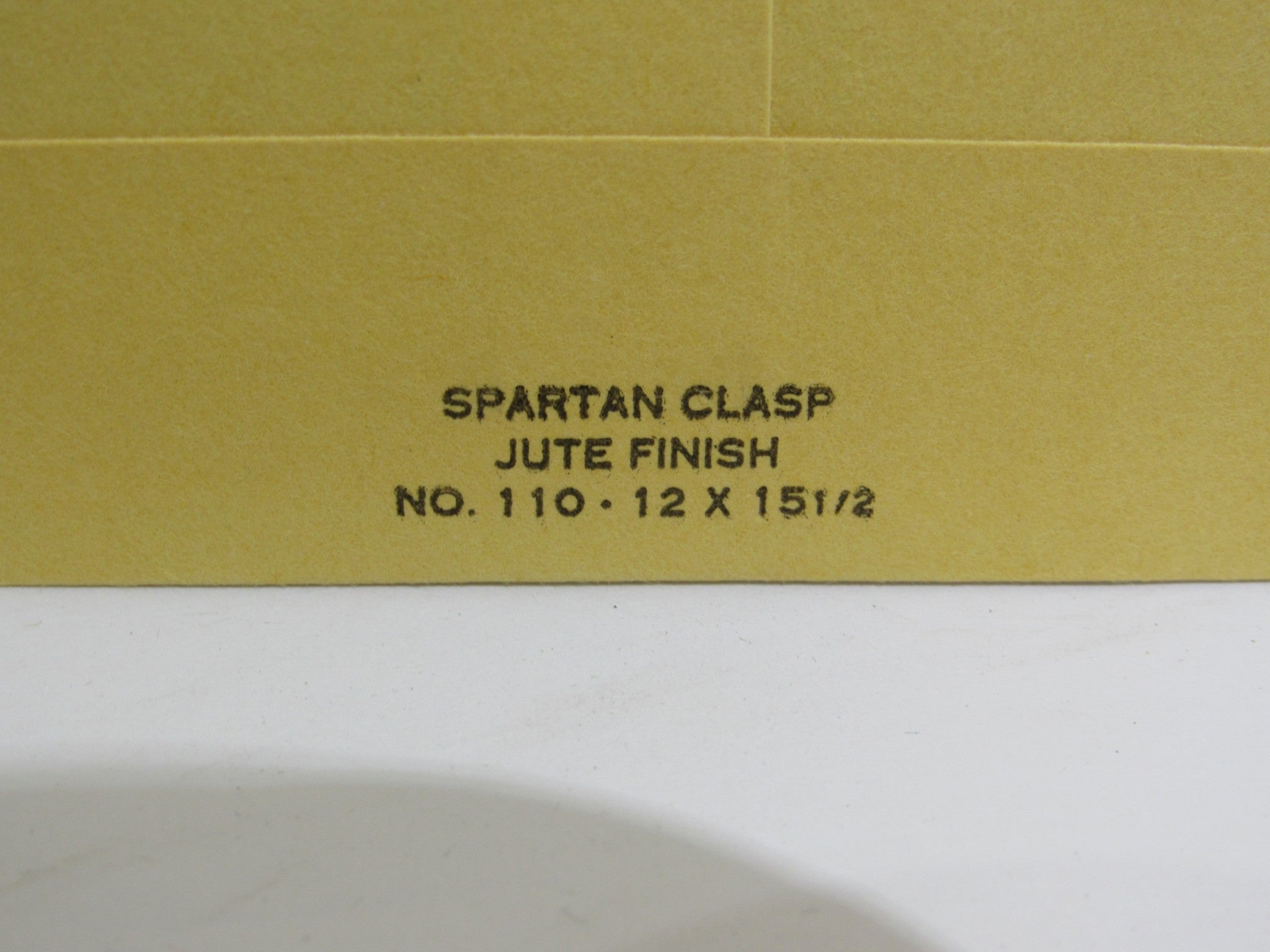 Detail of Spartan Clasp in jute finish, size 12 x 15 1/2, featured on the record Rain La Vache Qui Rit from Peterbilt Records, 1990 Rock LP, grade VG.