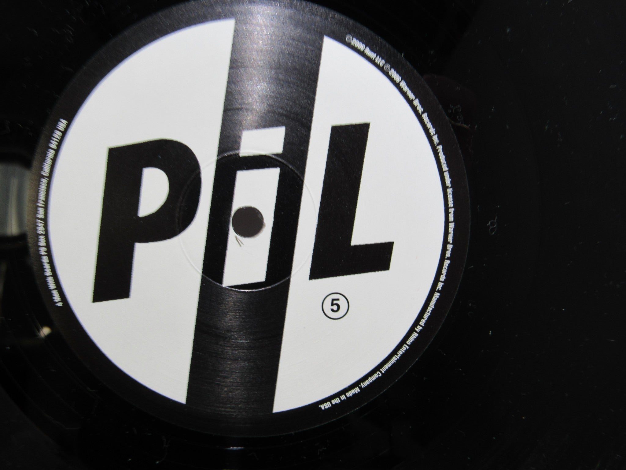 Close-up of the label on the Public Image Limited Metal Box 4 Men With Beards vinyl record, featuring the logo and catalog number.