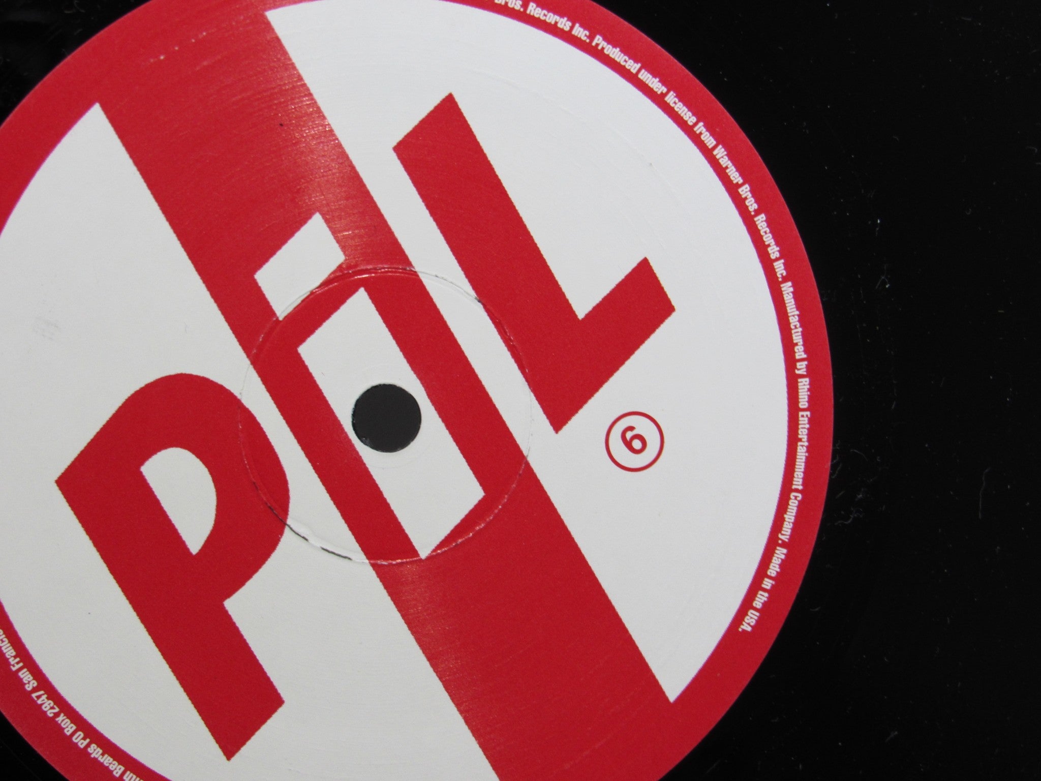 Detail of the label on the Public Image Limited Metal Box vinyl record, indicating the catalog number and track listing.