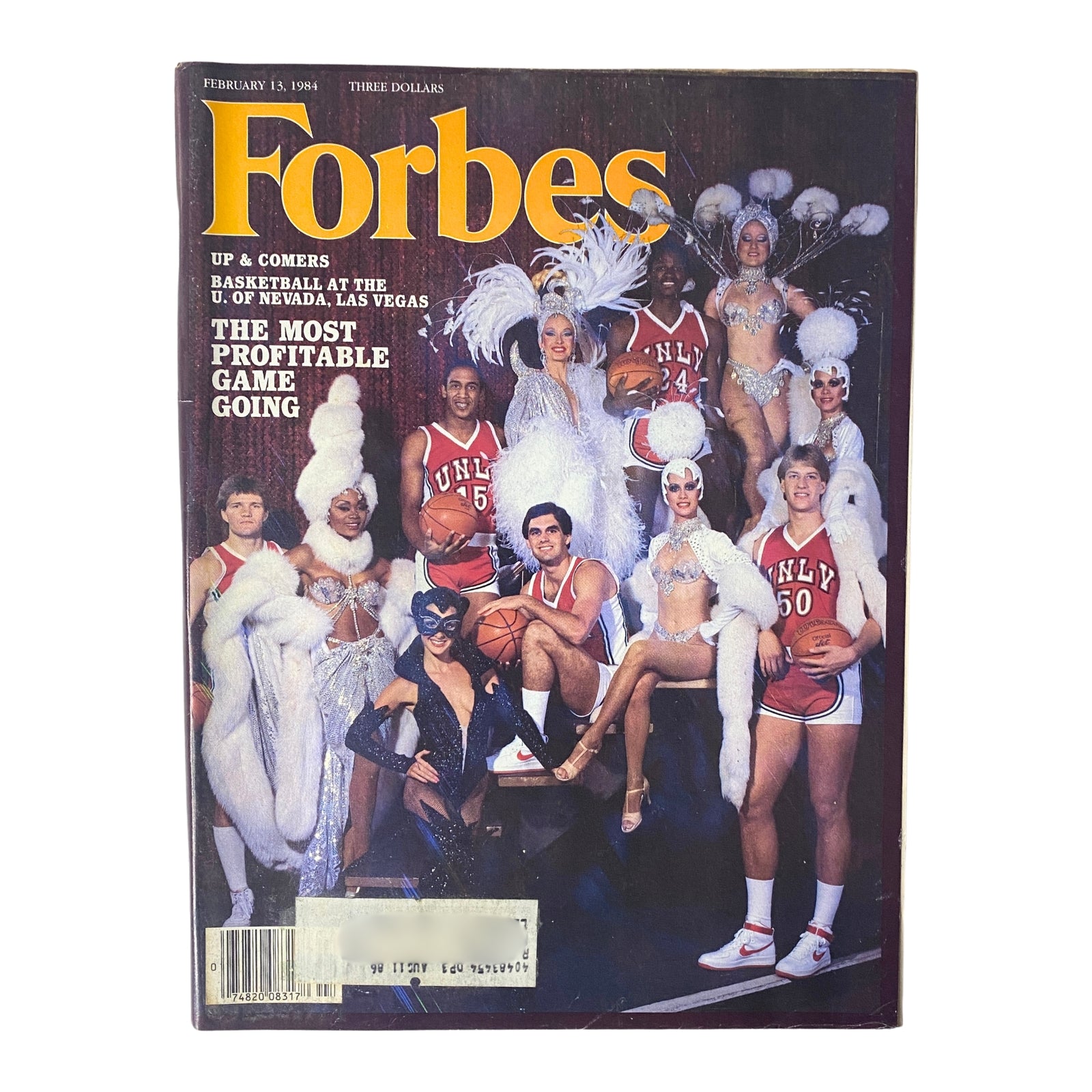 Cover of Forbes Magazine from February 13, 1984, titled 'The Most Profitable Game Going,' featuring basketball players and performers associated with the University of Nevada, Las Vegas, showcasing the blend of sports and entertainment.