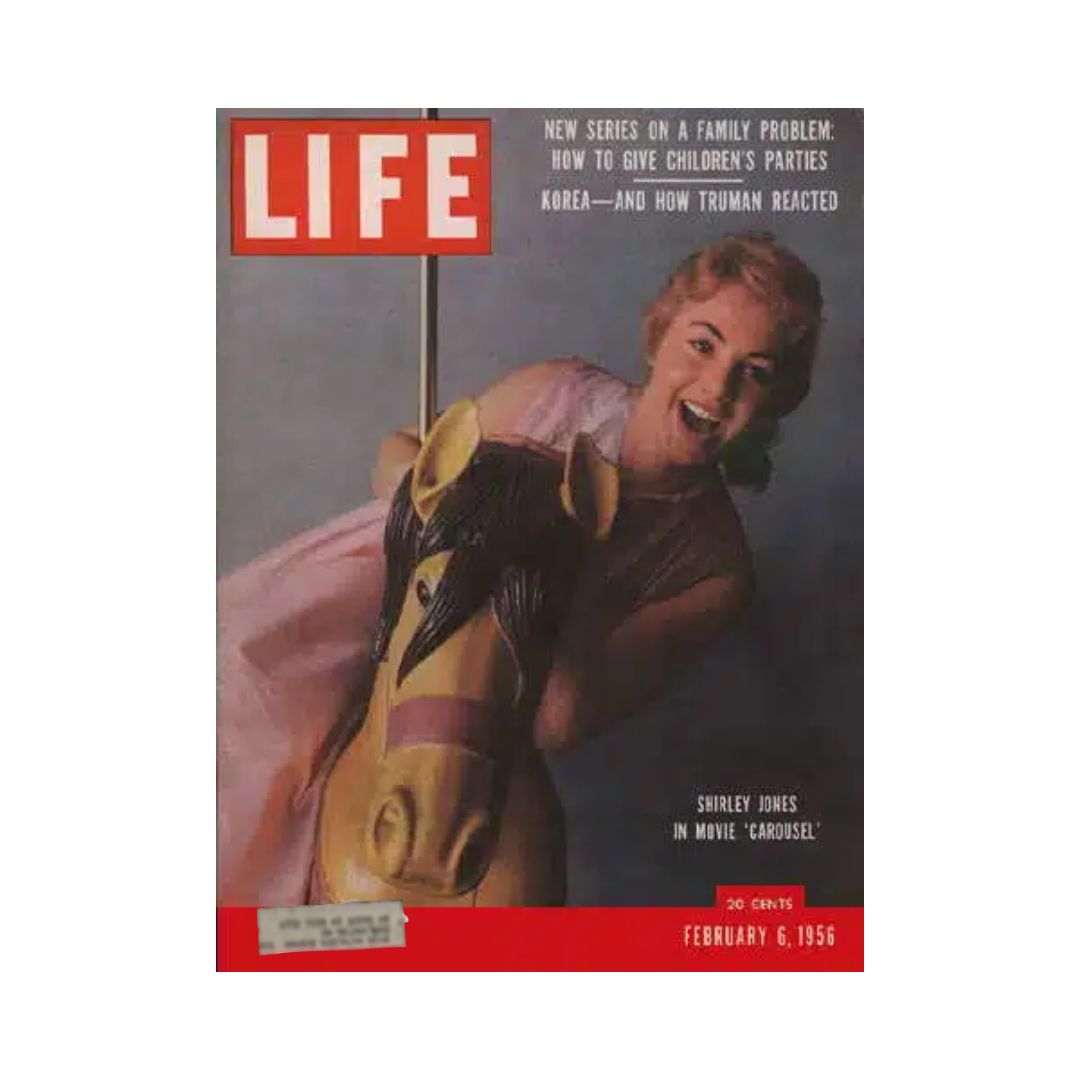 Vintage Life Magazine from February 6, 1956, featuring Shirley Jones on the cover in a playful moment with a carousel horse, promoting the movie 'Carousel'.