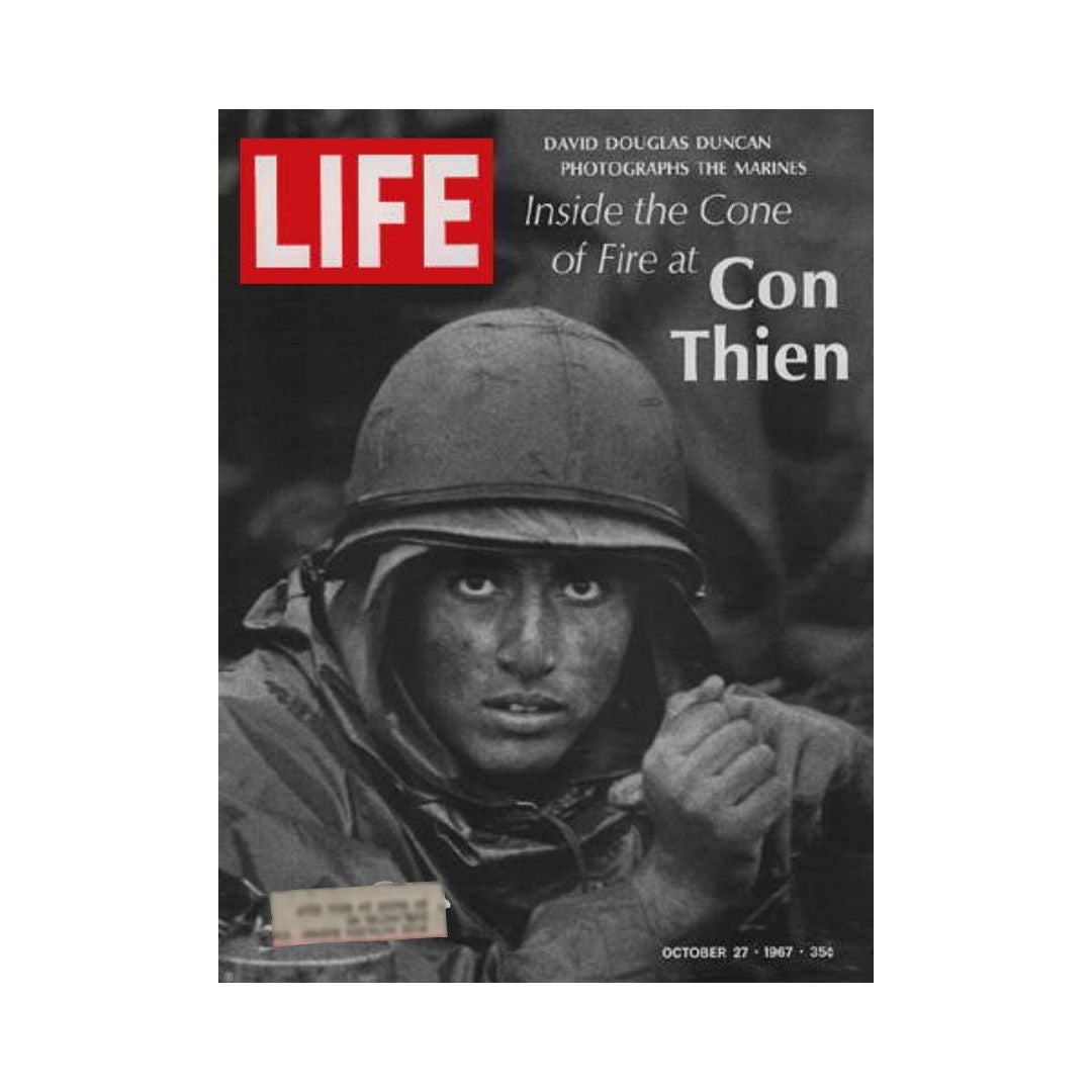 VTG Life Magazine cover from October 27, 1967 featuring a U.S. Marine at Con Thien during the Vietnam War, photographed by David Douglas Duncan. The image showcases the intensity of combat with a soldier in a helmet, expressing resilience amidst challenging conditions.