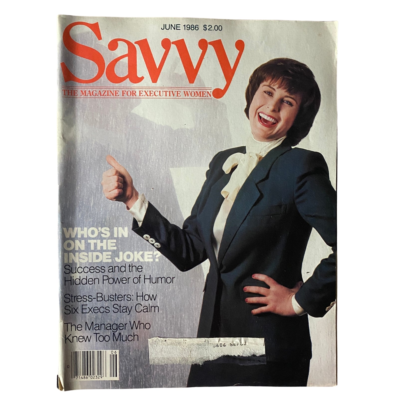 Savvy Magazine June 1986 cover featuring a smiling woman in a formal suit, promoting articles on women's professional development and the corporate landscape.