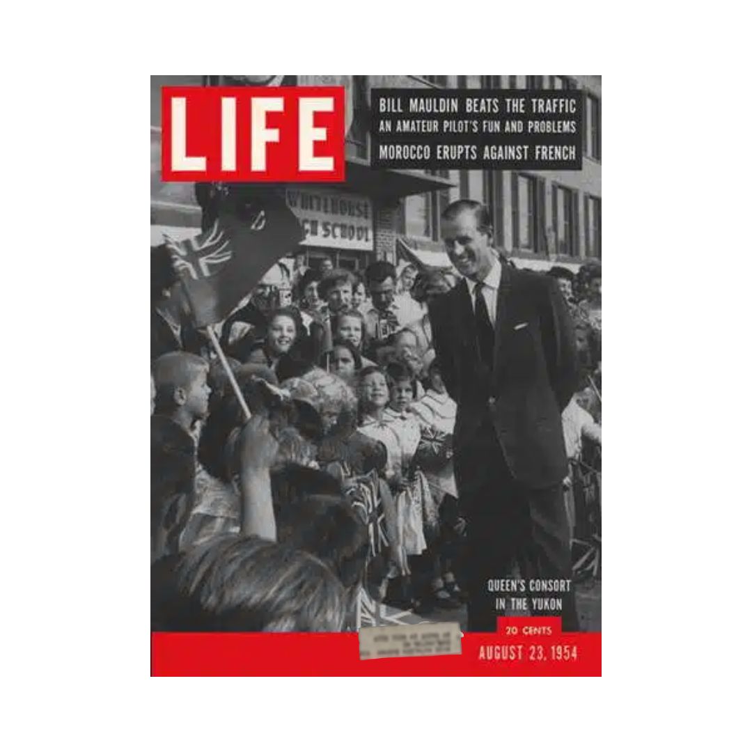 August 23, 1954 Life Magazine cover featuring the Duke of Edinburgh during his visit to the Yukon, capturing a historic moment with crowds and flags. This vintage issue showcases the royal visit and cultural events of the 1950s.