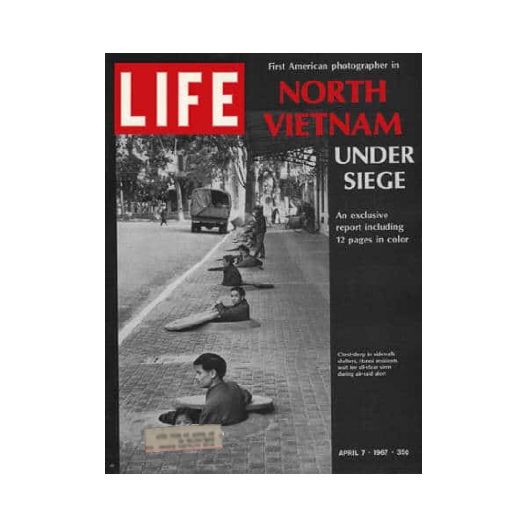 Cover of Life Magazine from April 7, 1967, featuring the title 'North Vietnam Under Siege'. The image shows people in narrow sidewalk shelters during an air raid alert, reflecting the war's impact in Vietnam.