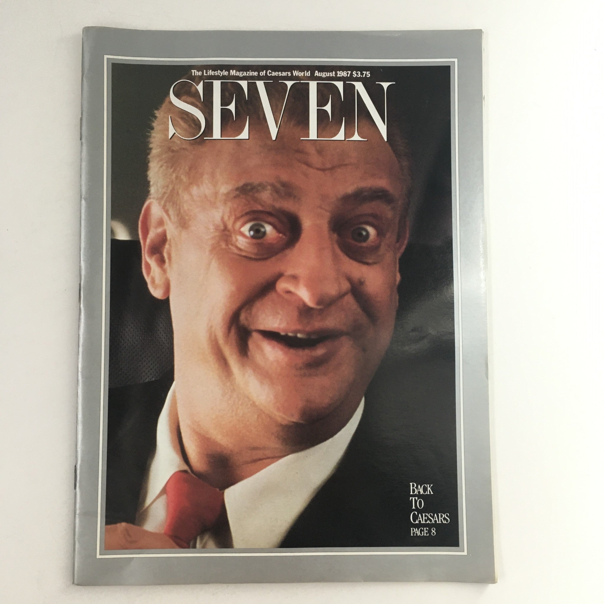 Cover of The Lifestyle Magazine of Caesars World Seven August 1987 featuring a smiling man, highlighting entertainment and lifestyle content, priced at $3.75.