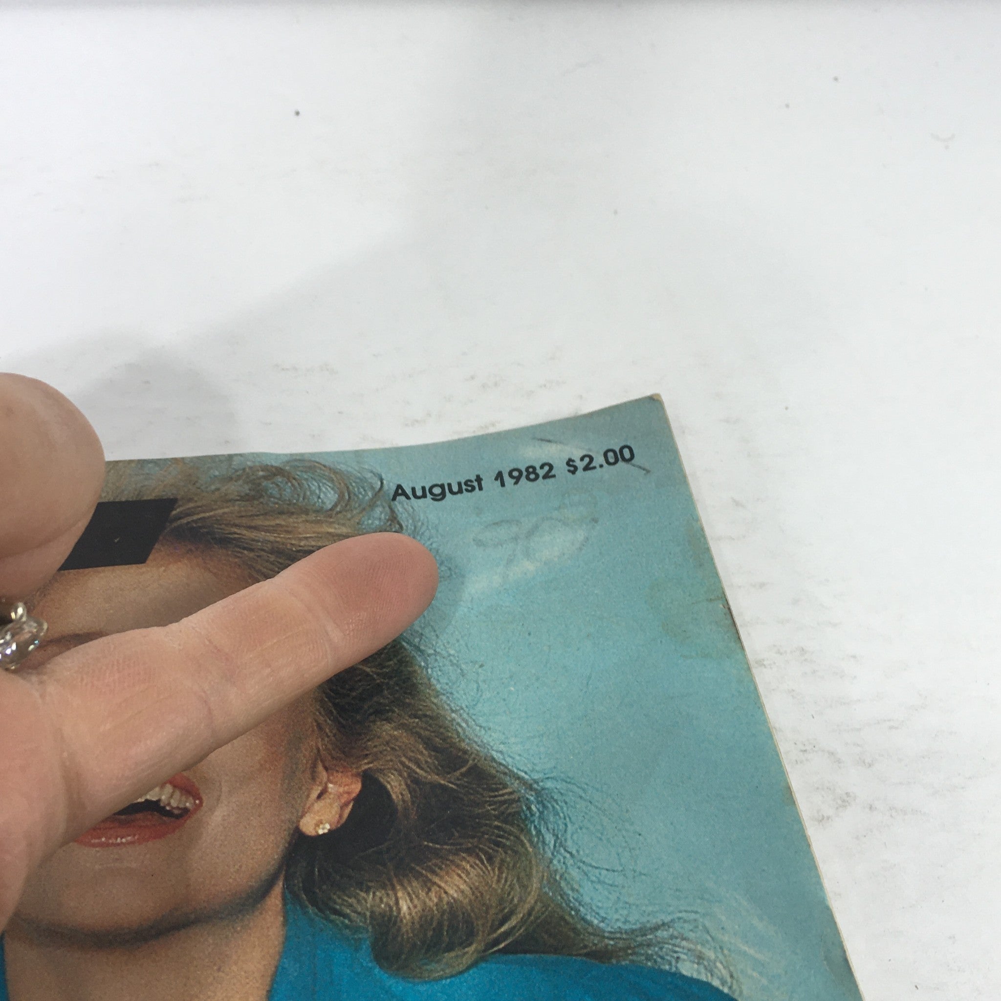 Close-up of the Fit Magazine: August 1982 cover featuring a smiling woman, highlighting the issue's publication date and price.
