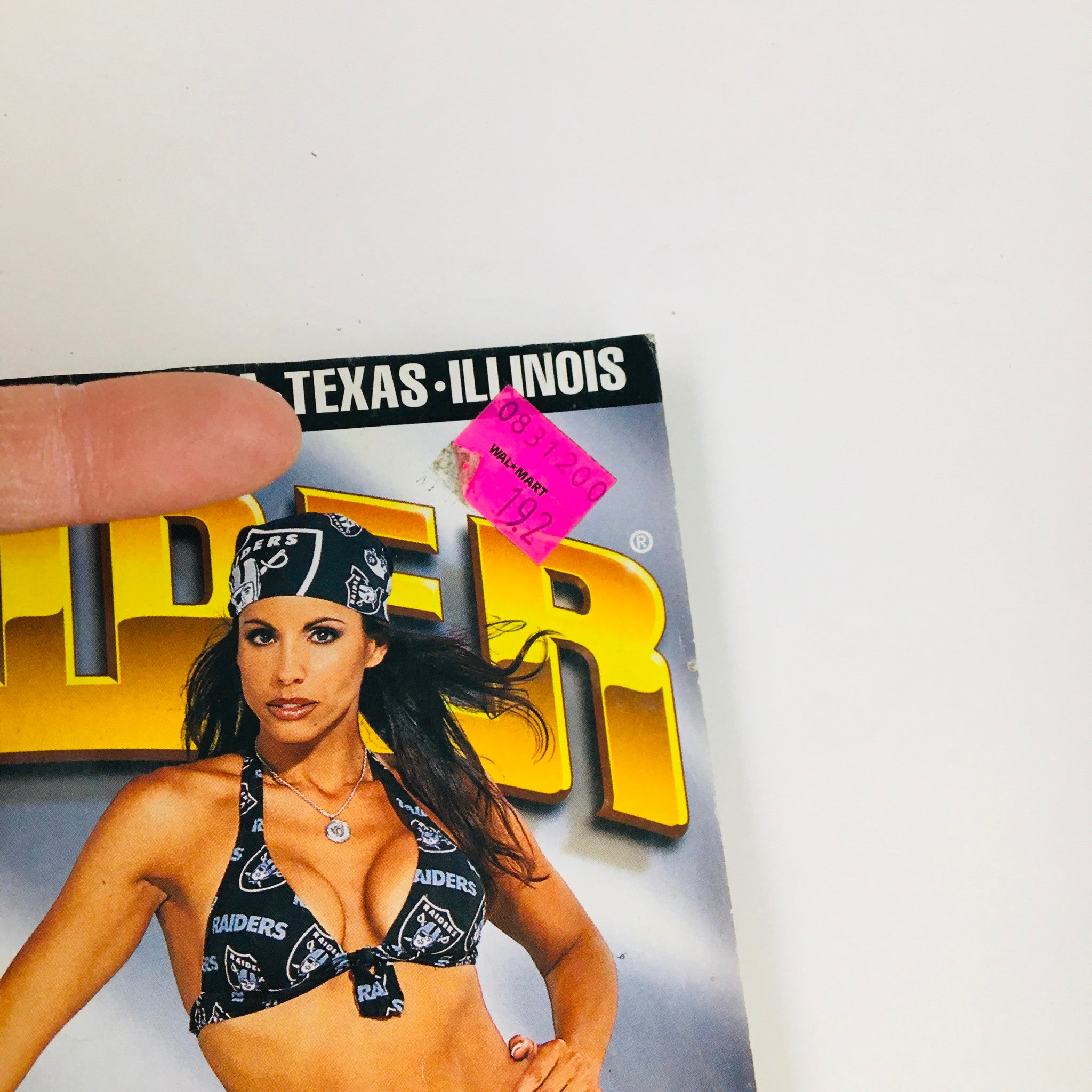 Close-up of the price sticker on the cover of LowRider Magazine October 2000, emphasizing its collectible nature and historical significance in the lowrider community.