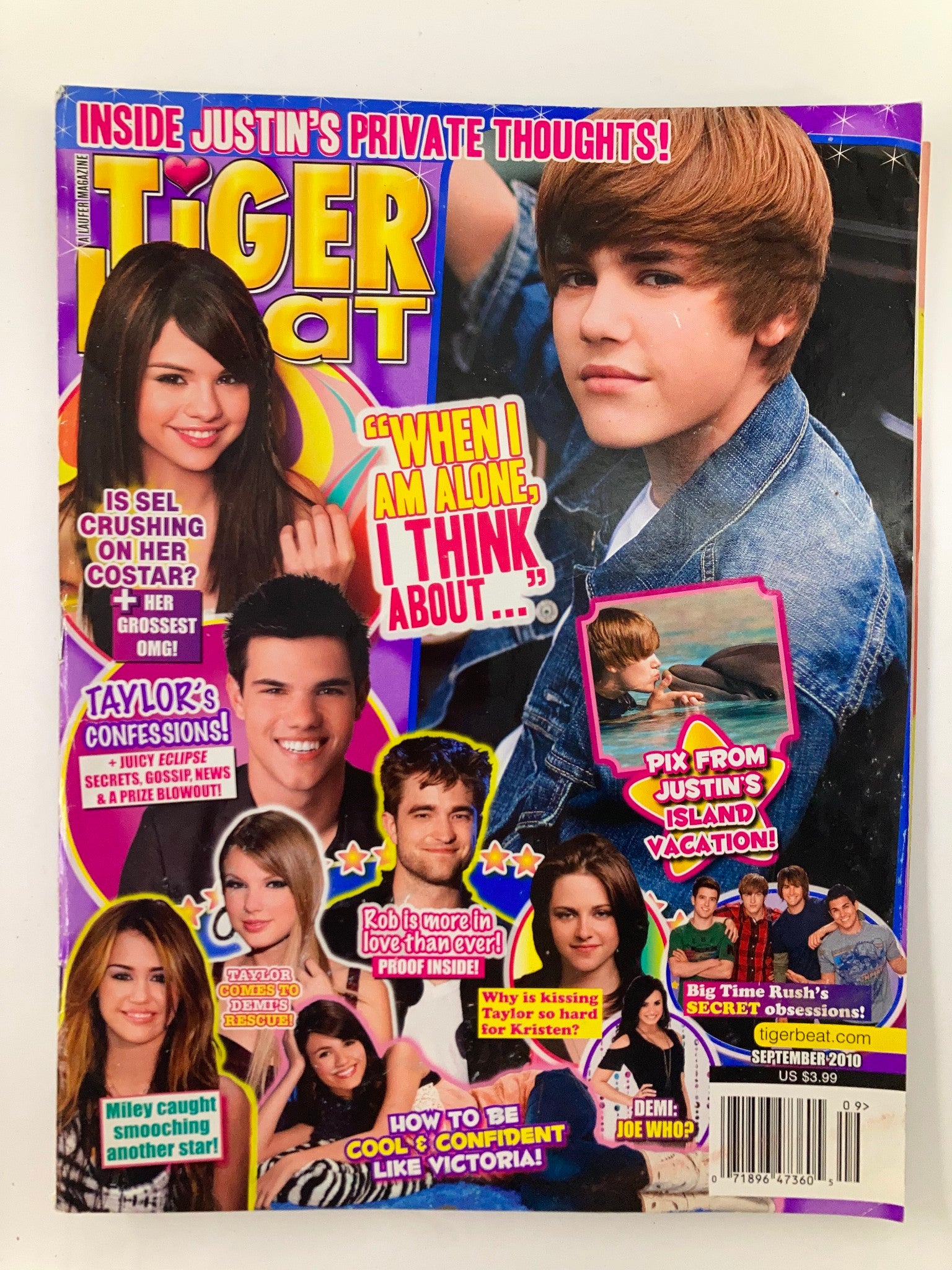 Cover of Tiger Beat Magazine September 2010 featuring Justin Bieber, Selena Gomez, and Taylor Lautner. The cover includes a quote about private thoughts and reveals exciting features such as vacation pictures and secrets from stars, making it a must-have collectible for fans.