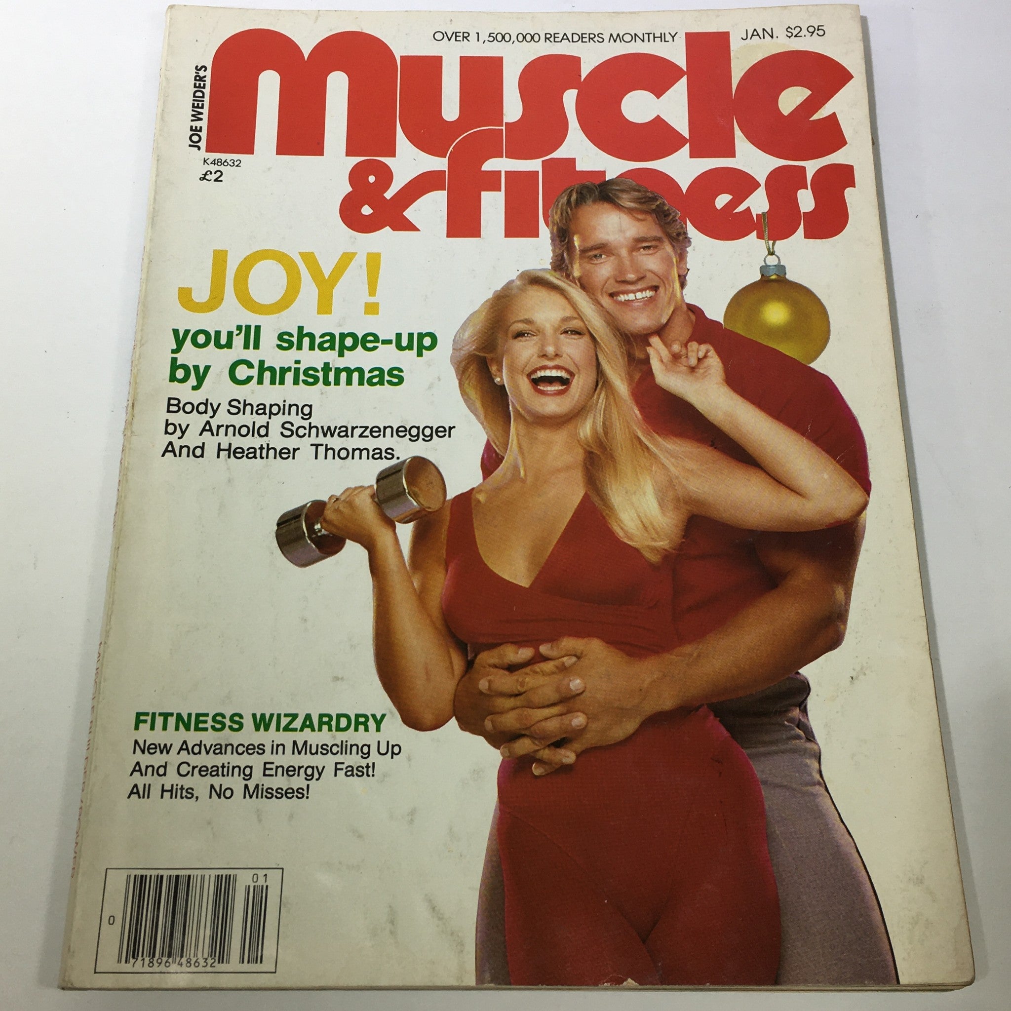 Cover of VTG Muscle & Fitness magazine from January 1982 featuring Arnold Schwarzenegger and Heather Thomas. The magazine focuses on body shaping and fitness tips, priced at $2.95. The cover showcases a cheerful aesthetic with Christmas themes.
