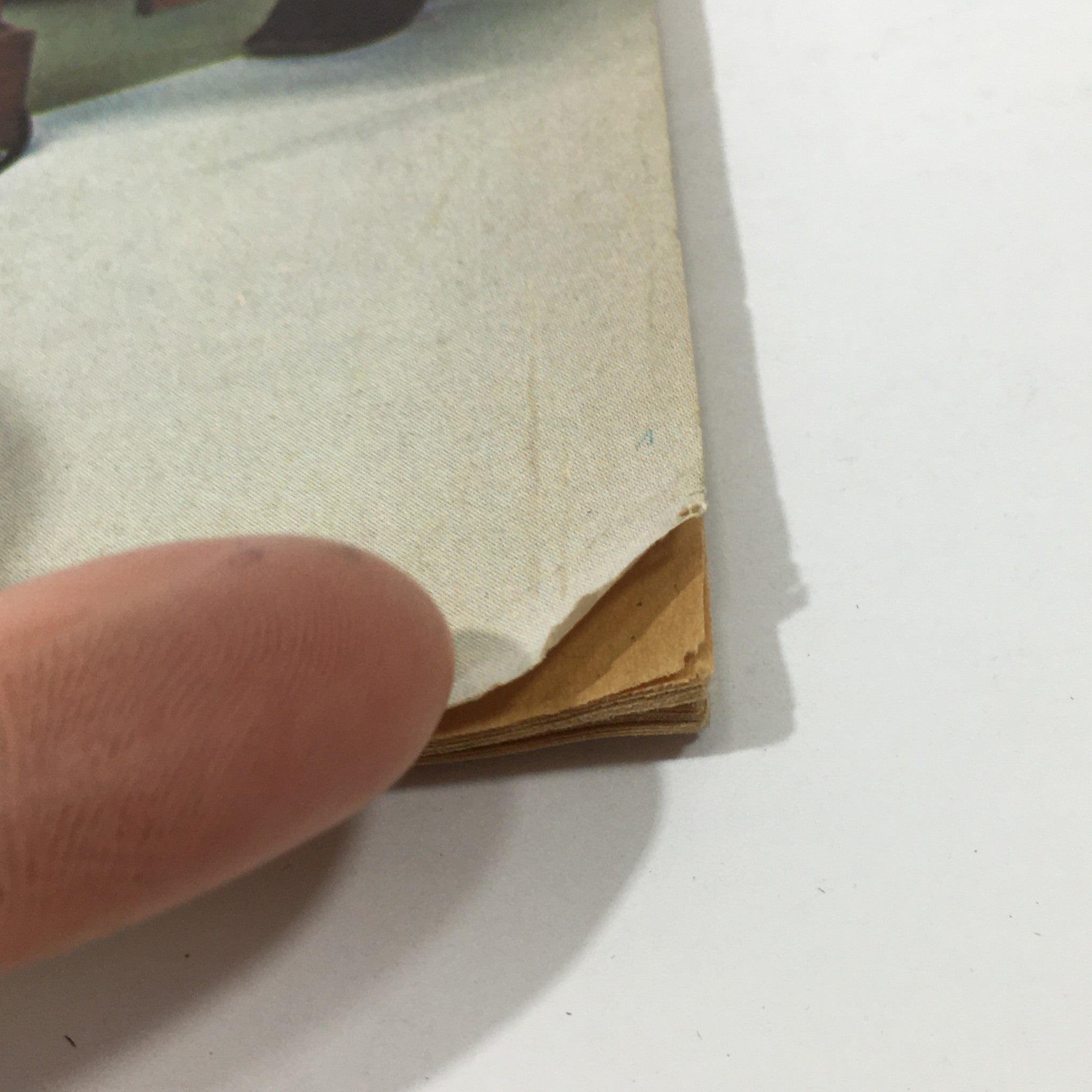 Detail of the spine of the Vintage Furniture Projects Magazine: 1976 Edition, showcasing age-related imperfections, characteristic of collectible vintage publications.