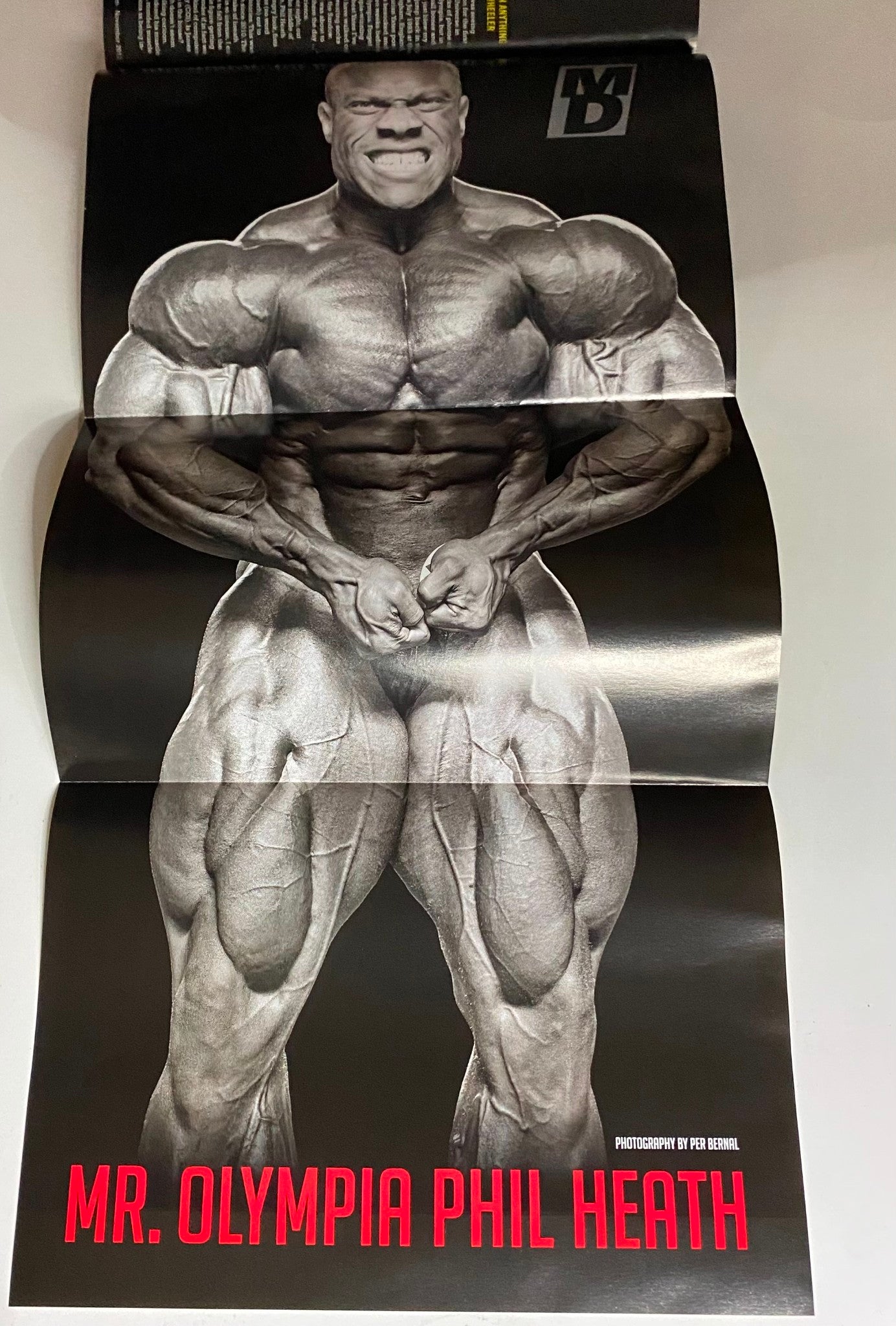 Fold-out poster of Mr. Olympia Phil Heath from Muscular Development Magazine November 2012, showcasing his impressive physique and detailing his journey in bodybuilding.