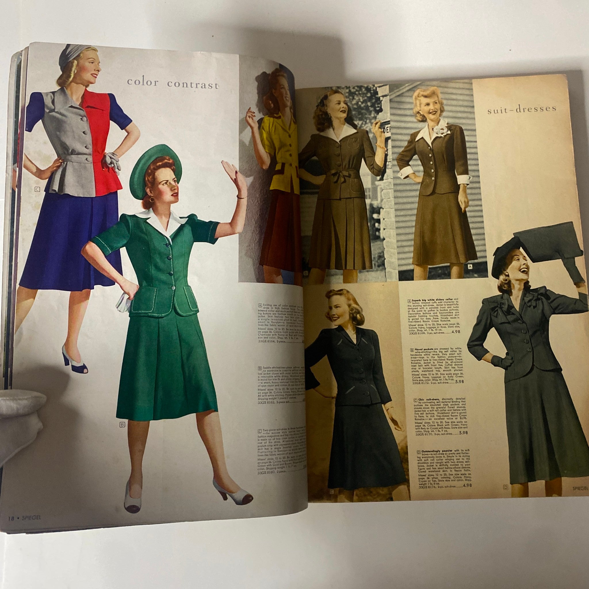 Interior pages of the 1943 Spiegel Spring and Summer Catalog highlighting colorful suit dresses, emphasizing mid-20th century fashion trends.
