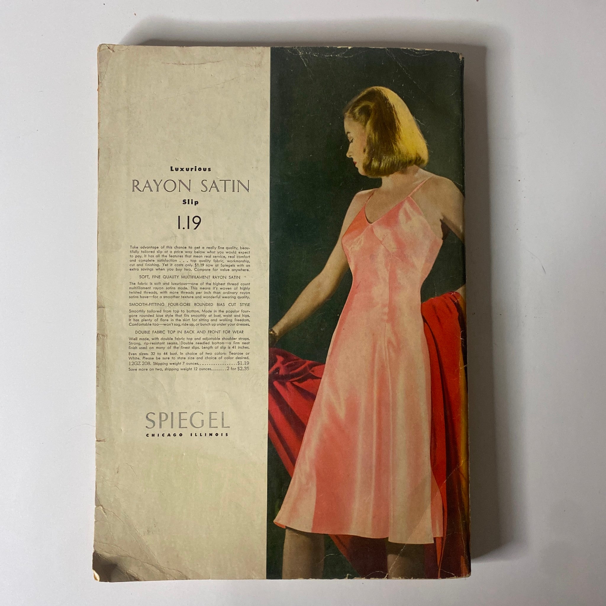 Cover of the 1943 Spiegel Spring and Summer Catalog showcasing a model in a luxurious pink rayon satin slip, emphasizing vintage fashion trends during World War II.