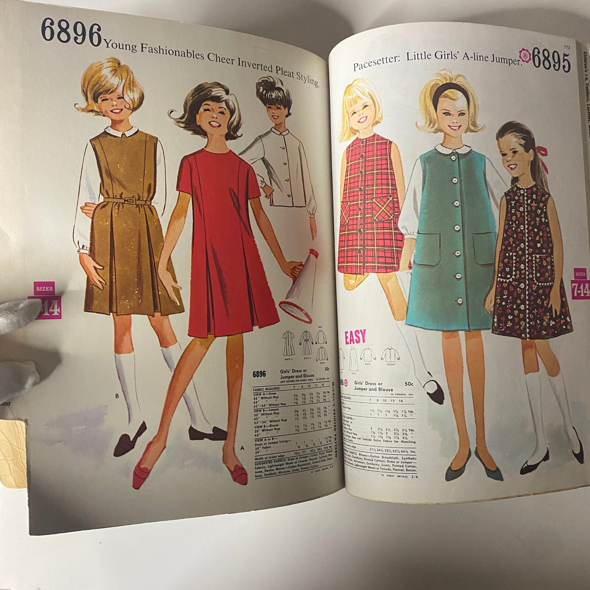 A page from the 1963 July McCall's Summerwear Catalog showcasing children's fashion patterns including girls' dresses and jumpers with various styles and fabric options.