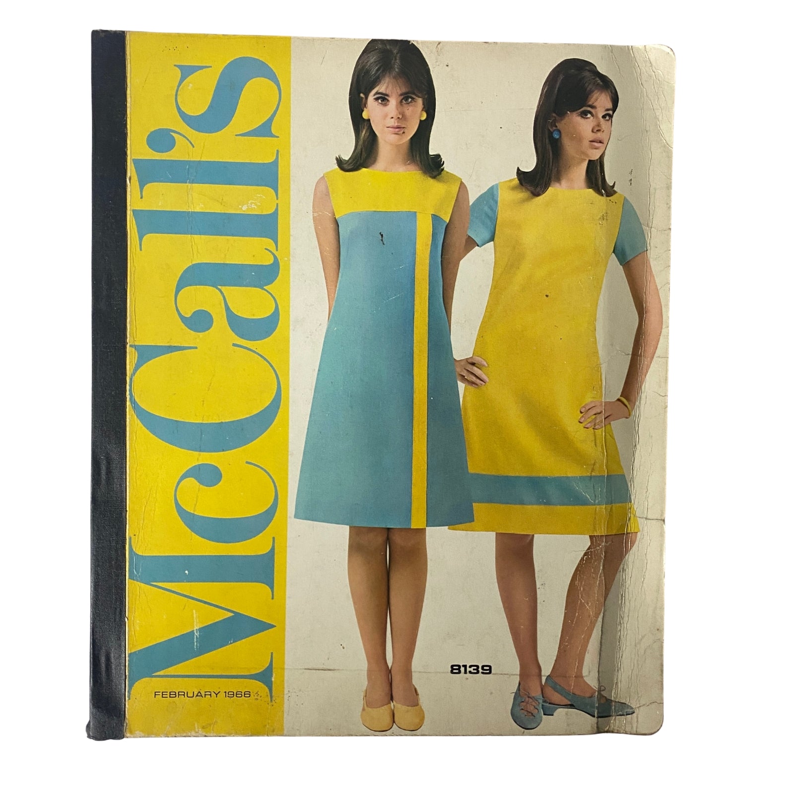 Cover of the 1966 February McCall's Designers' Collection catalog featuring two women modeling colorful mid-1960s dresses in blue and yellow.