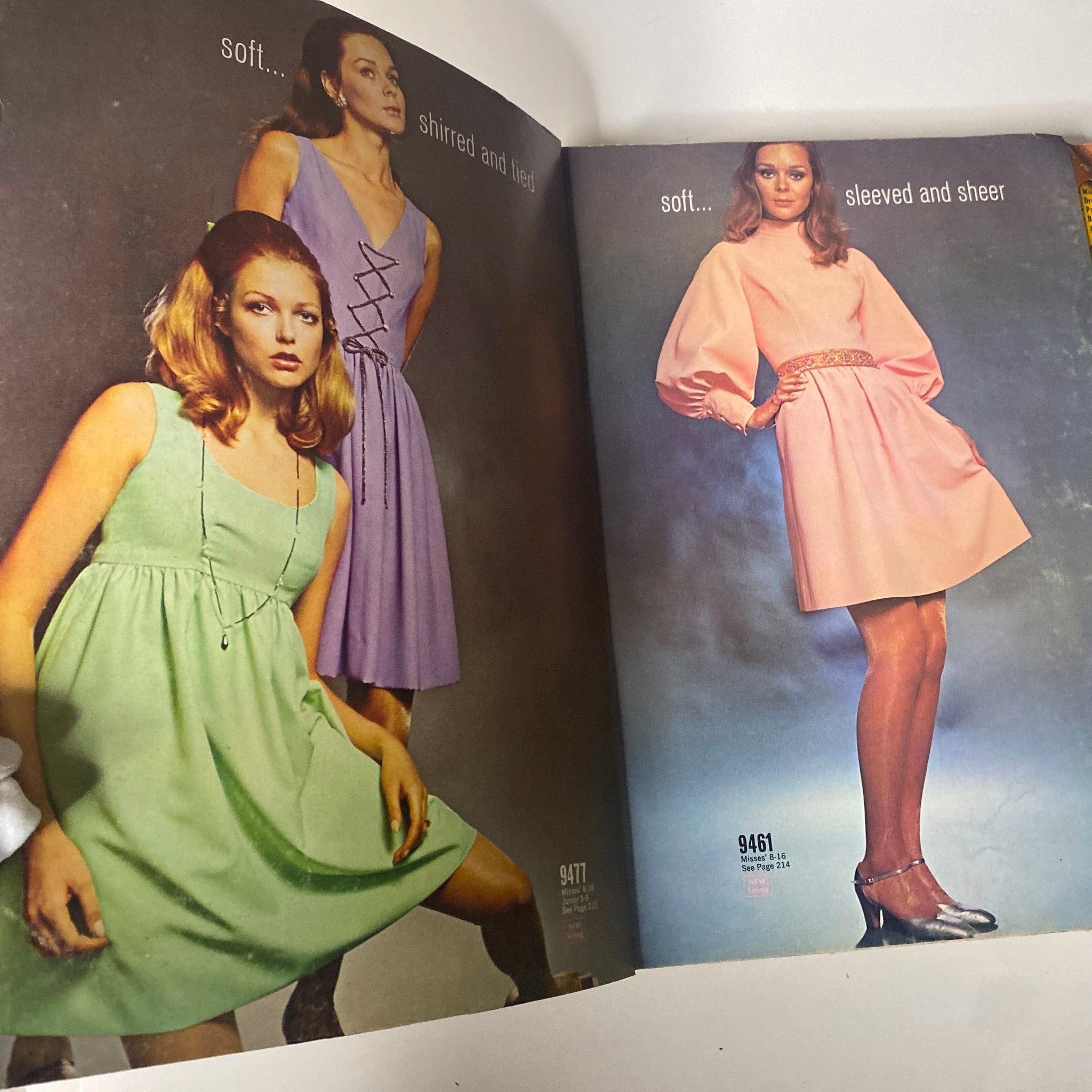 Inside spread of the 1968 November McCall's Holiday Wear Catalog displaying three stylish holiday dresses in pastel colors, highlighting designs that emphasize soft fabrics and elegant silhouettes.