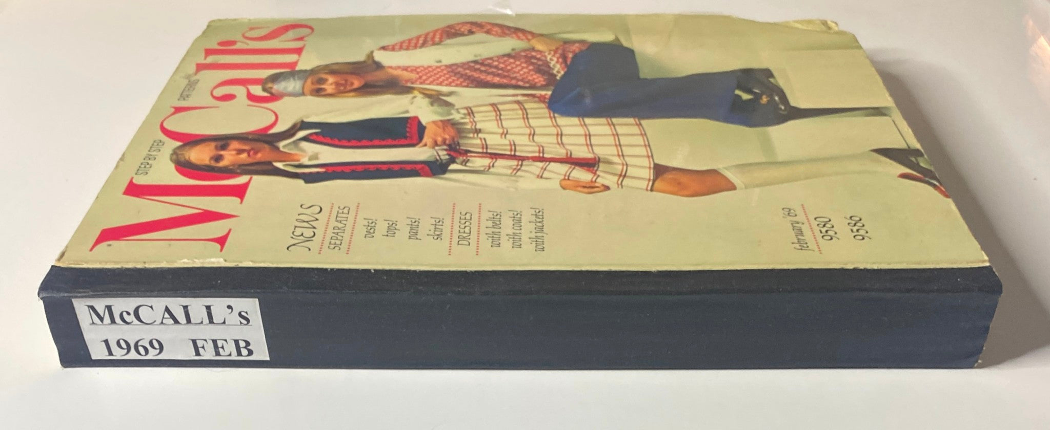 Cover of the 1969 February McCall's Step by Step Patterns Catalog featuring two models showcasing retro outfits, highlighting fashion styles of the era.