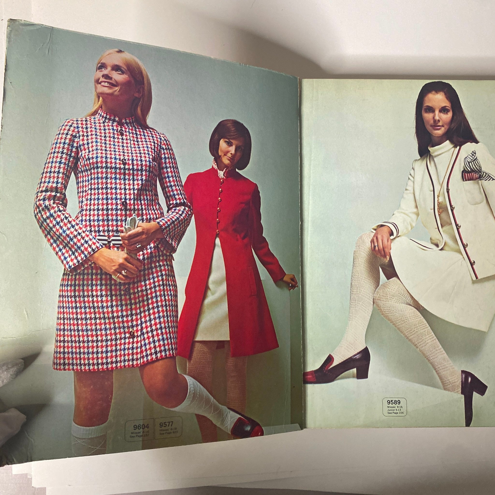 Inside pages of the 1969 February McCall's Step by Step Patterns Catalog displaying stylish designs of dresses and coats worn by models in a vibrant color palette.