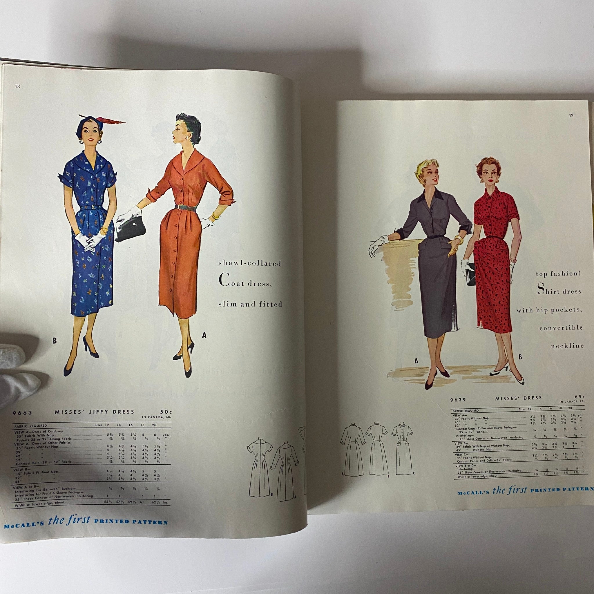 Page of the 1954 July McCall's The First Printed Pattern Catalog presenting coat dress designs with shawl-collared details and fitted styles, showcasing classic 1950s fashion.