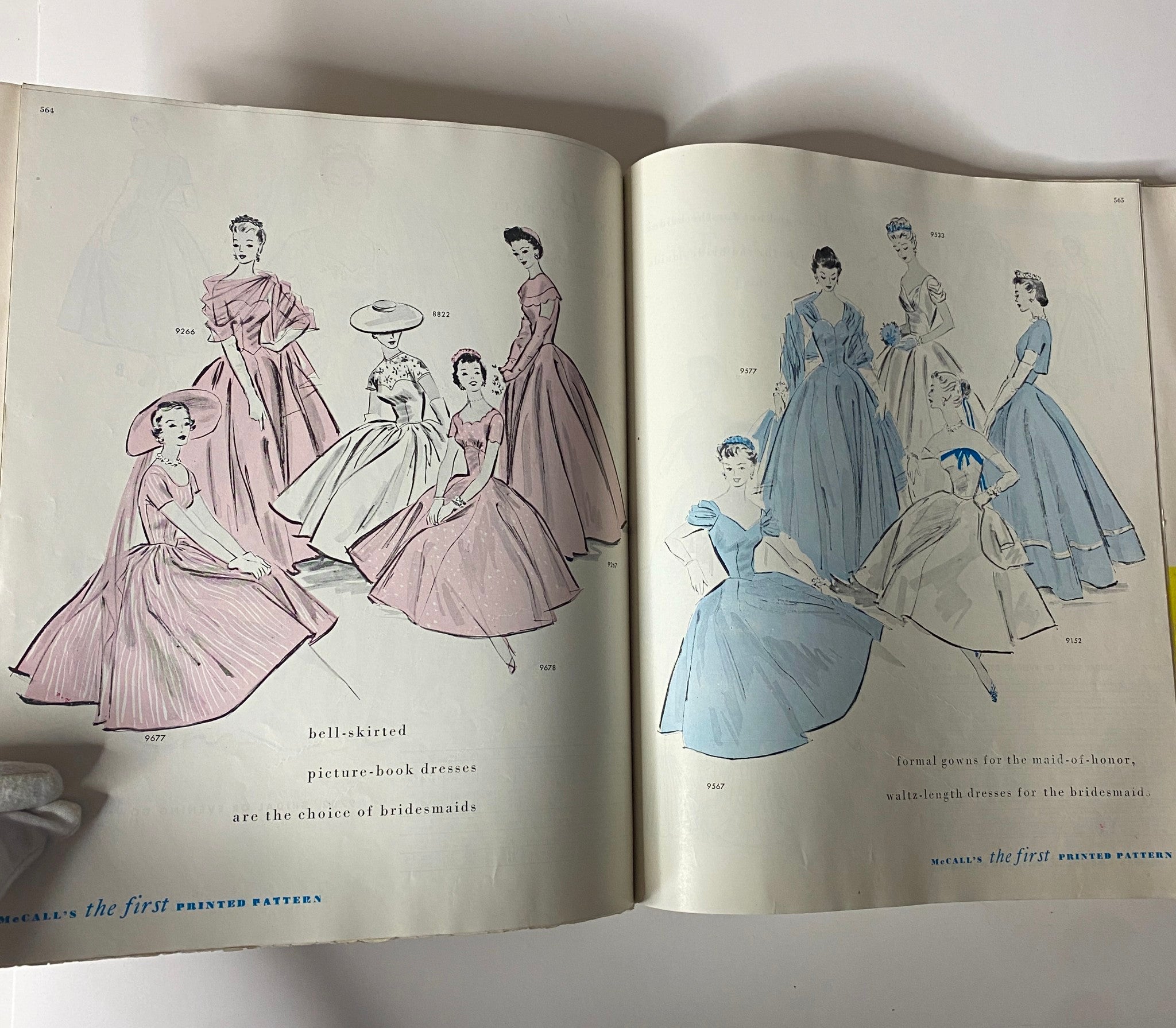 1954 July McCall's The First Printed Pattern displaying a page of beautiful bell-skirted dresses ideal for bridesmaids, showcasing elegant formal wear designs.