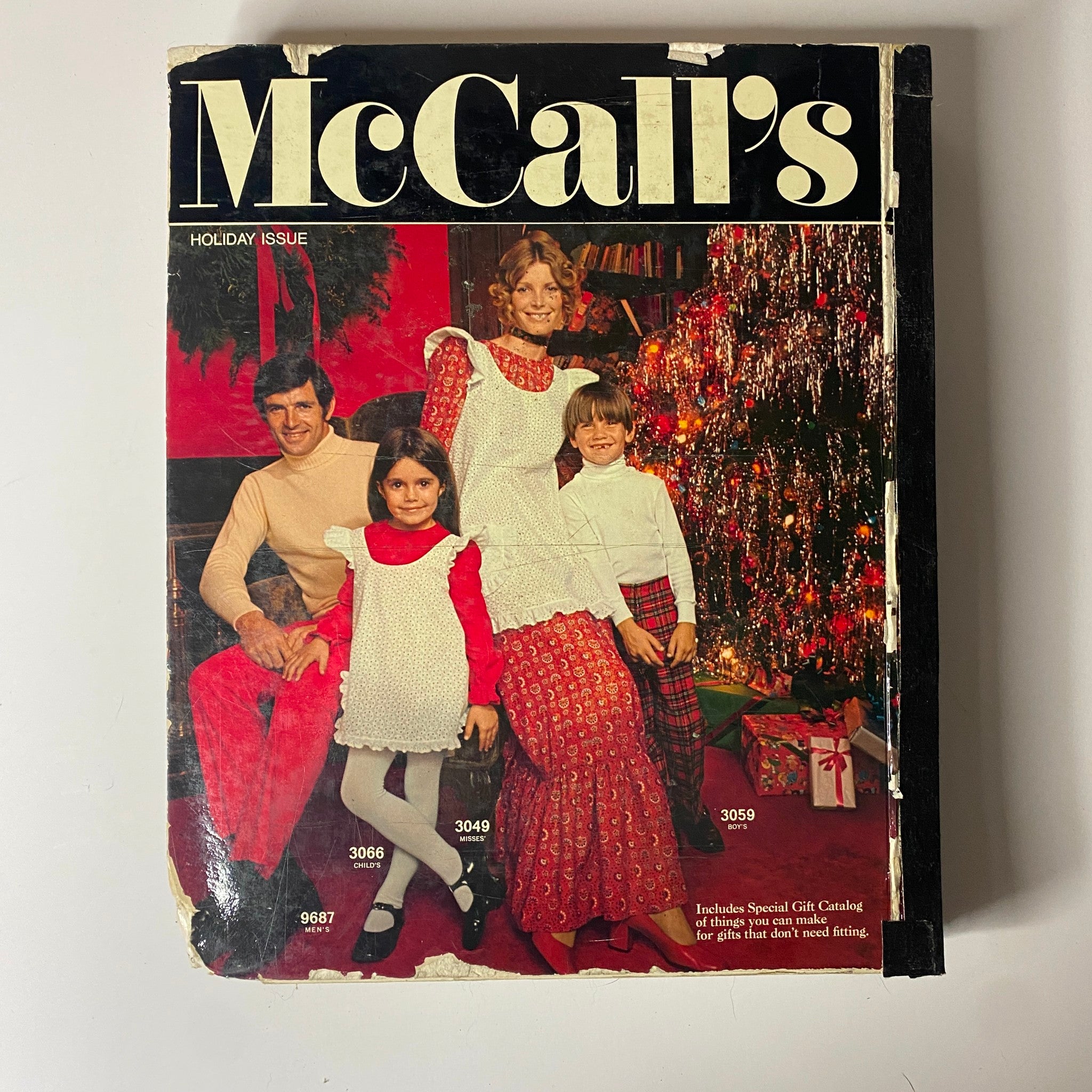 1971 McCall's Christmas Holiday Issue cover featuring a family dressed in holiday attire, surrounded by Christmas decorations, highlighting family fashion inspired by mid-century styles.