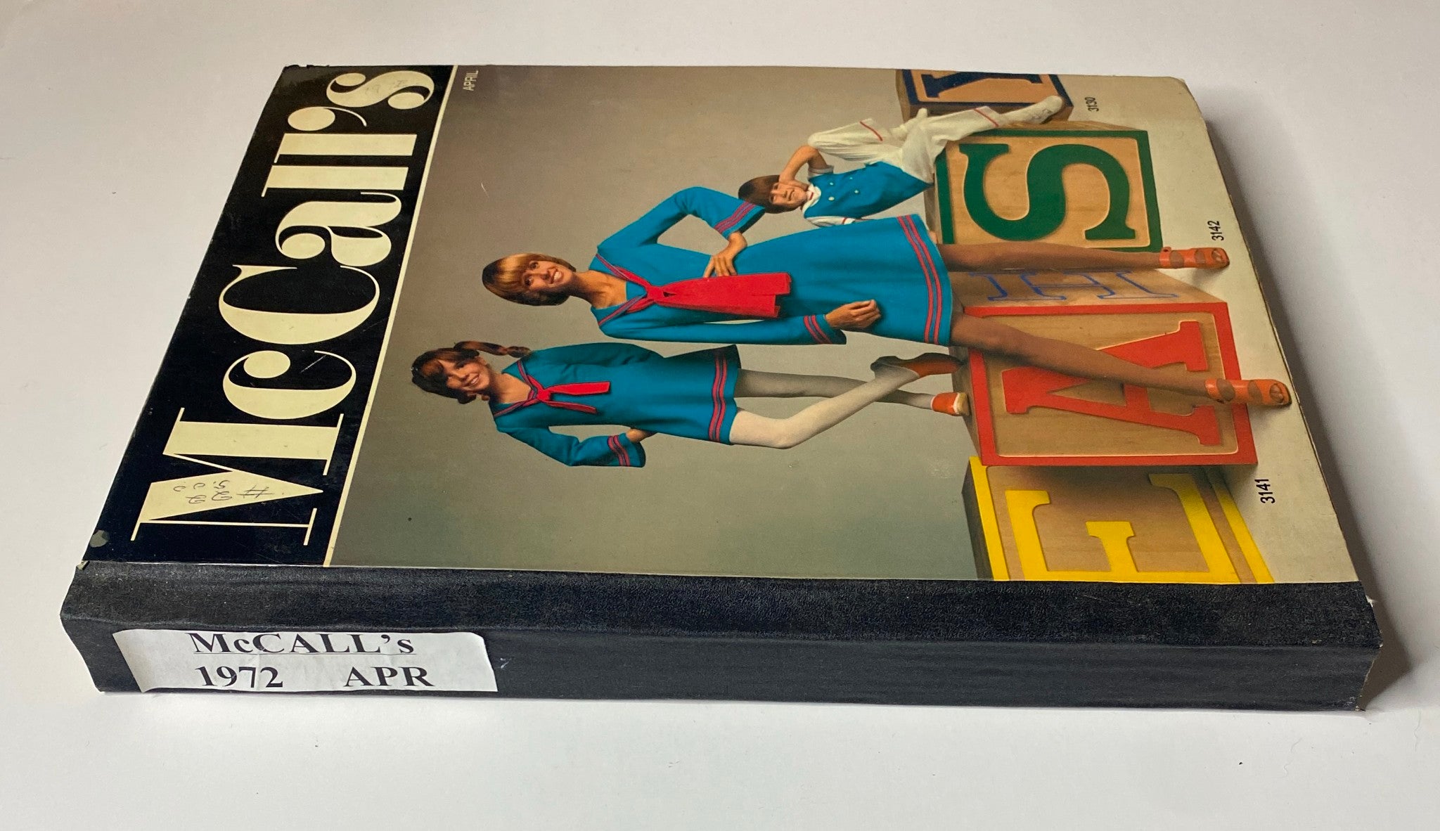 Side view of the 1972 April McCall's Catalog, highlighting the unique design and vibrant fashion illustrations. The catalog provides a glimpse into 1970s style and home sewing patterns.