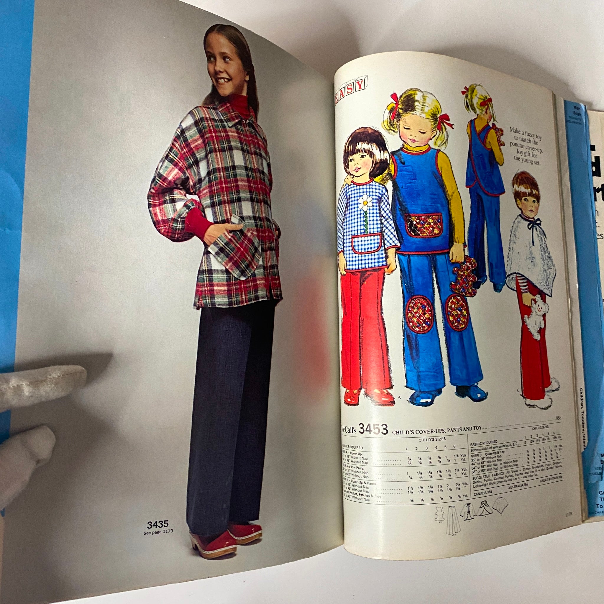 1972 McCall's Holiday Huge Store Retail Counter Catalog showcasing a girl's plaid coat and a collection of colorful children's clothing patterns.