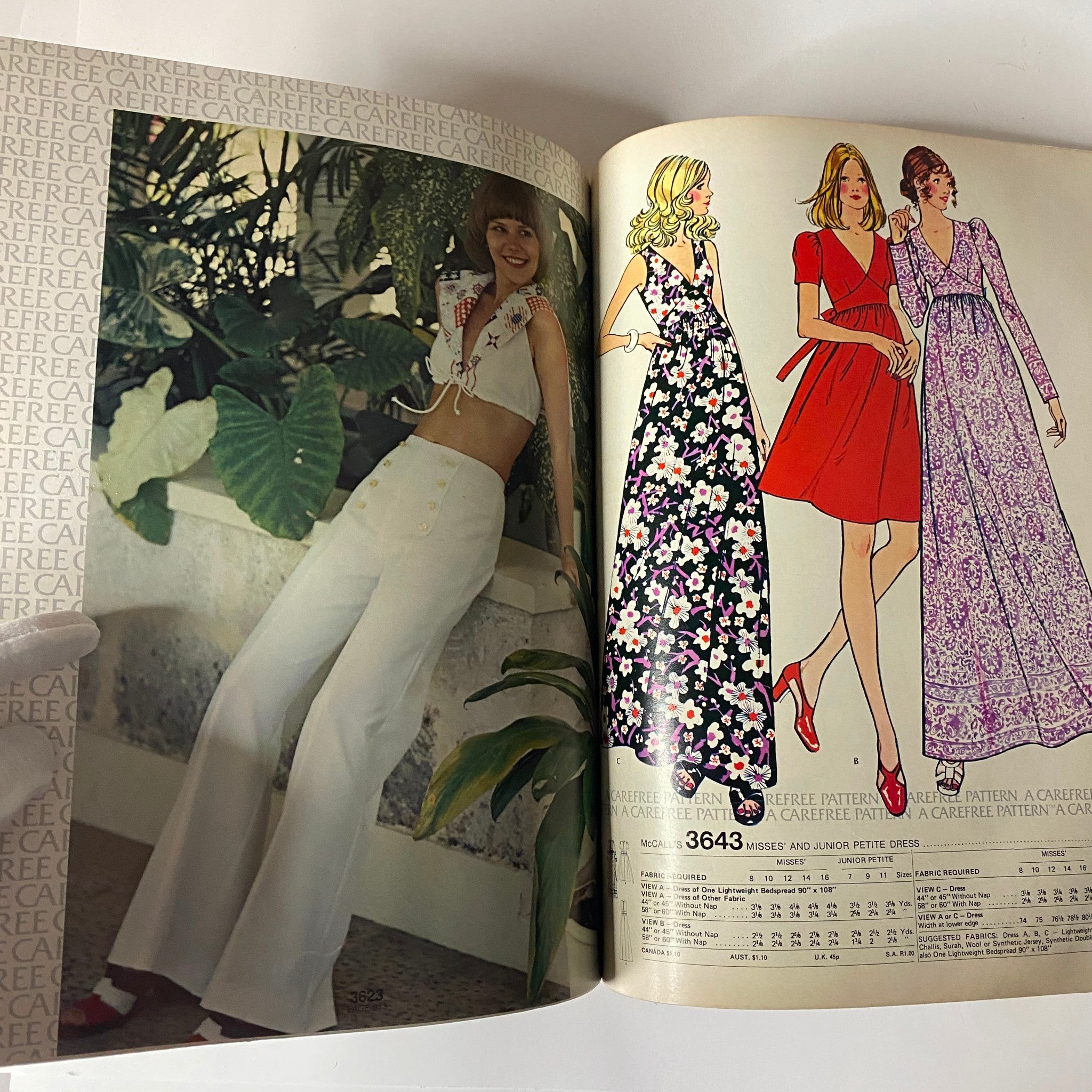 1973 July - August McCall's Carefree Patterns catalog image with a woman in a tie-front top and wide-leg pants, displayed with floral dress illustrations.