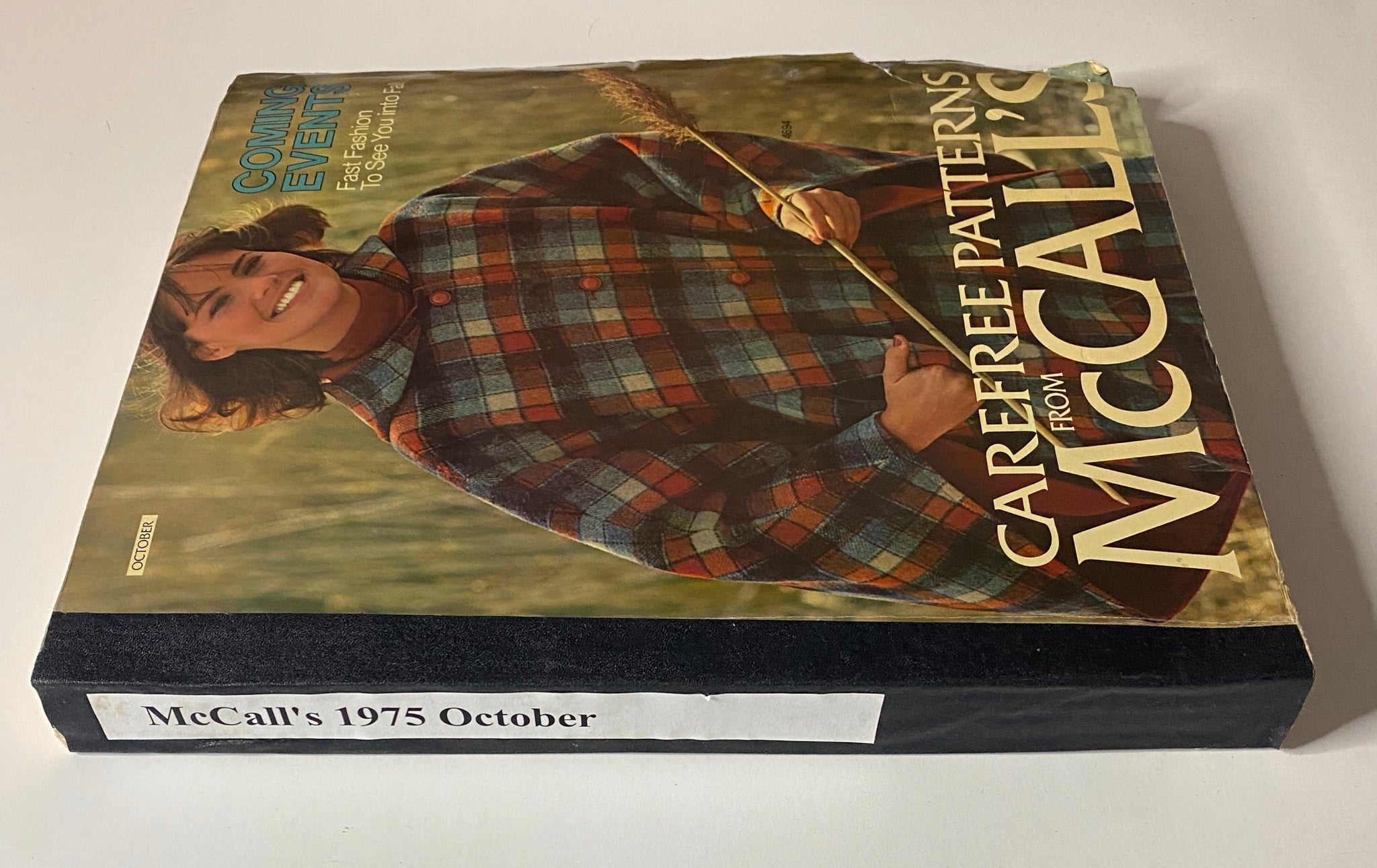 Side view of 1975 October Carefree Patterns from McCall's catalog, highlighting the model in plaid and the title indicating fast fashion for fall.