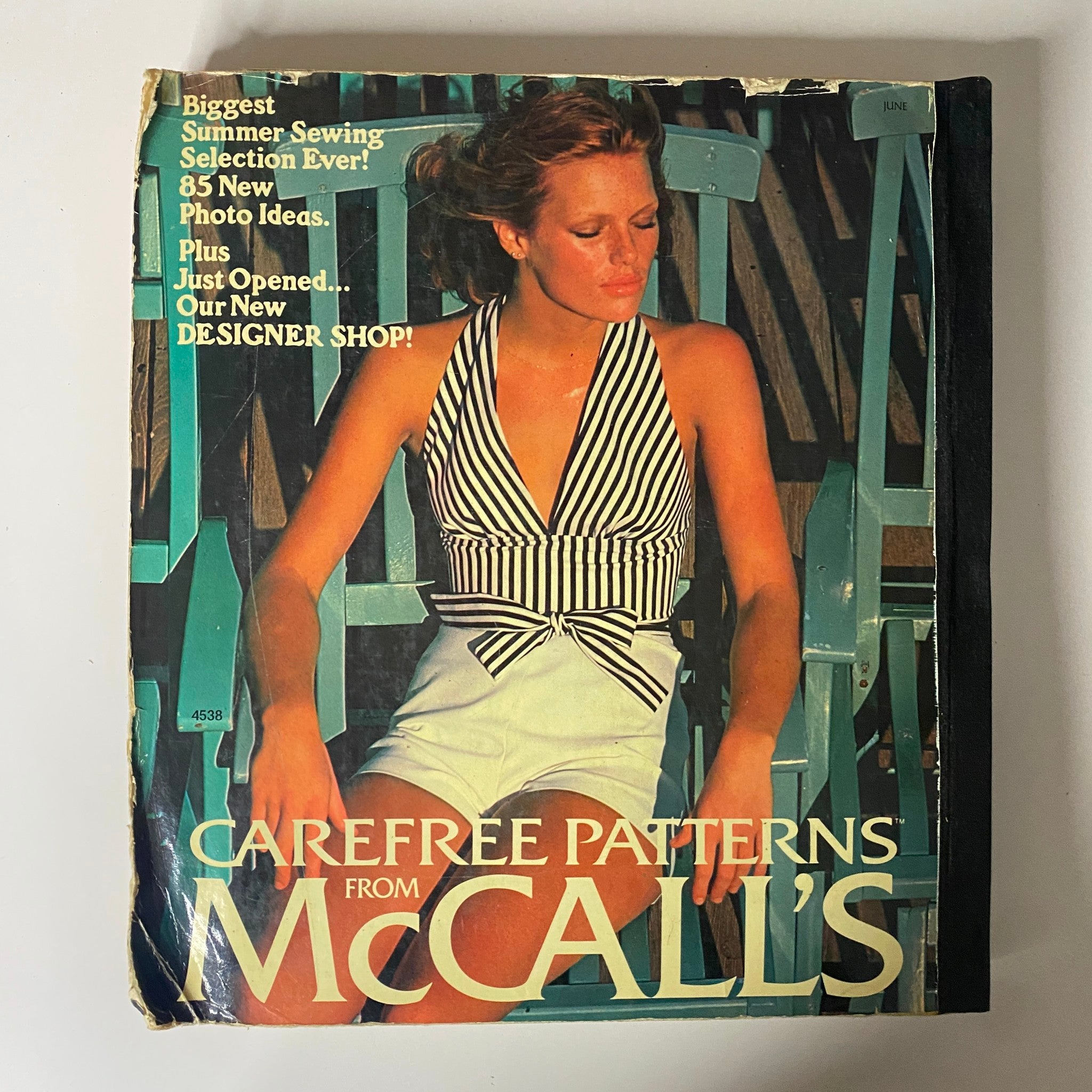Cover of the 1975 Carefree Patterns McCall's Summer Catalog featuring a woman in a stylish striped swimsuit, highlighting the biggest summer sewing selection with text emphasizing new photo ideas and designer shop.