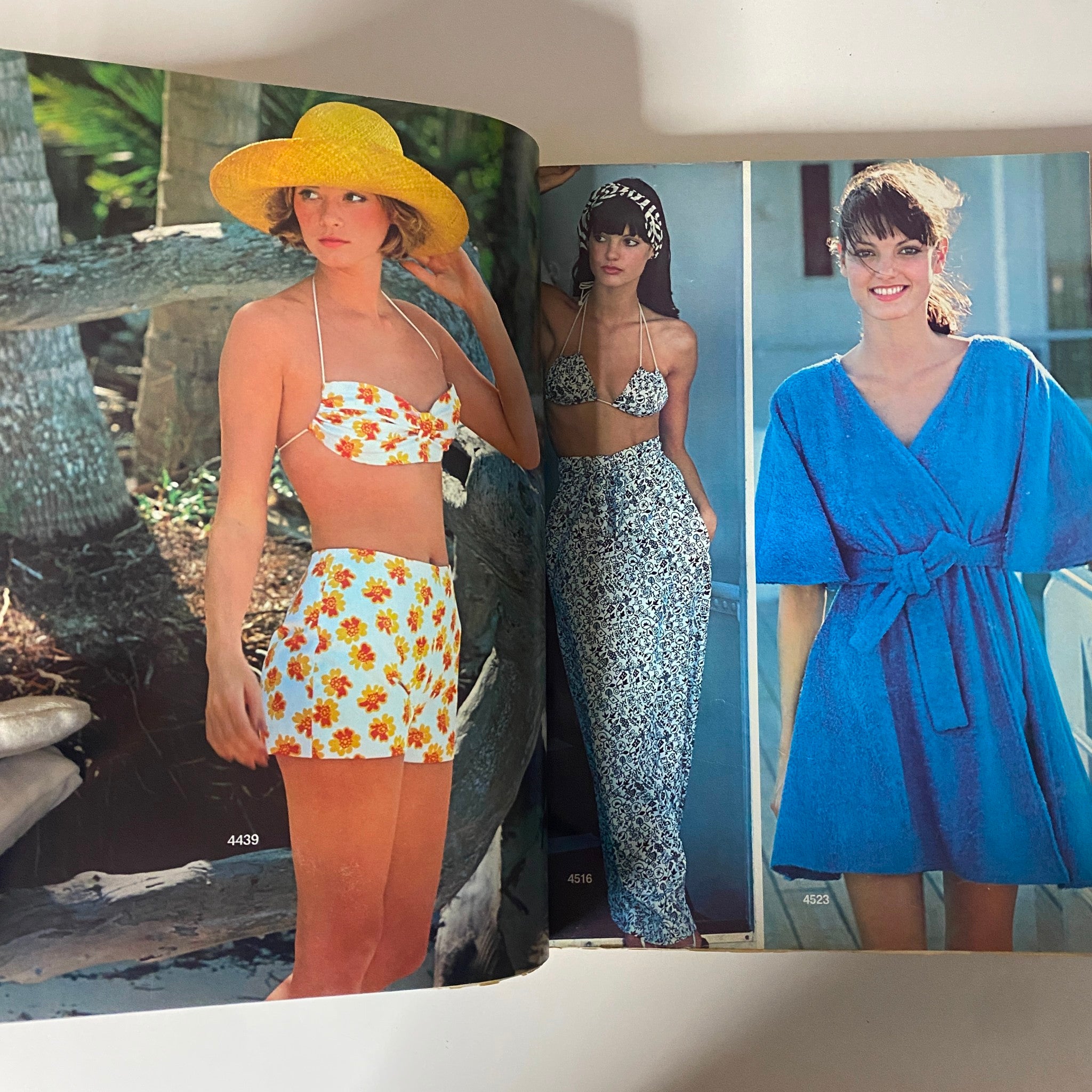 1975 June Carefree Patterns McCall's Catalog showcasing two women in summer outfits including a floral bikini and a blue dress, highlighting 1970s fashion trends.