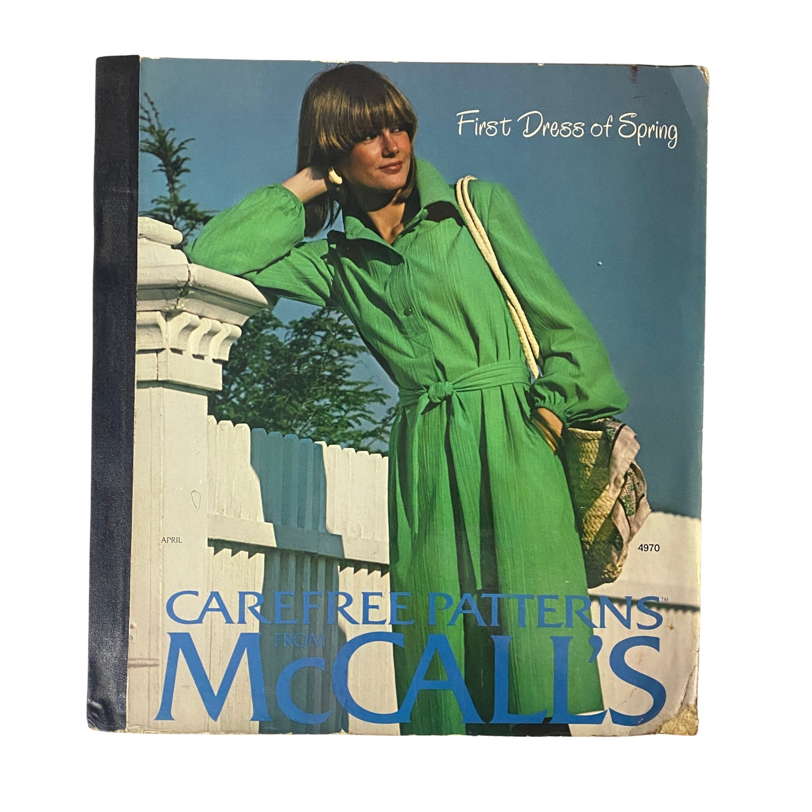 1976 April Carefree Patterns McCall's Spring Catalog cover featuring a model in a green dress, showcasing mid-1970s fashion style.