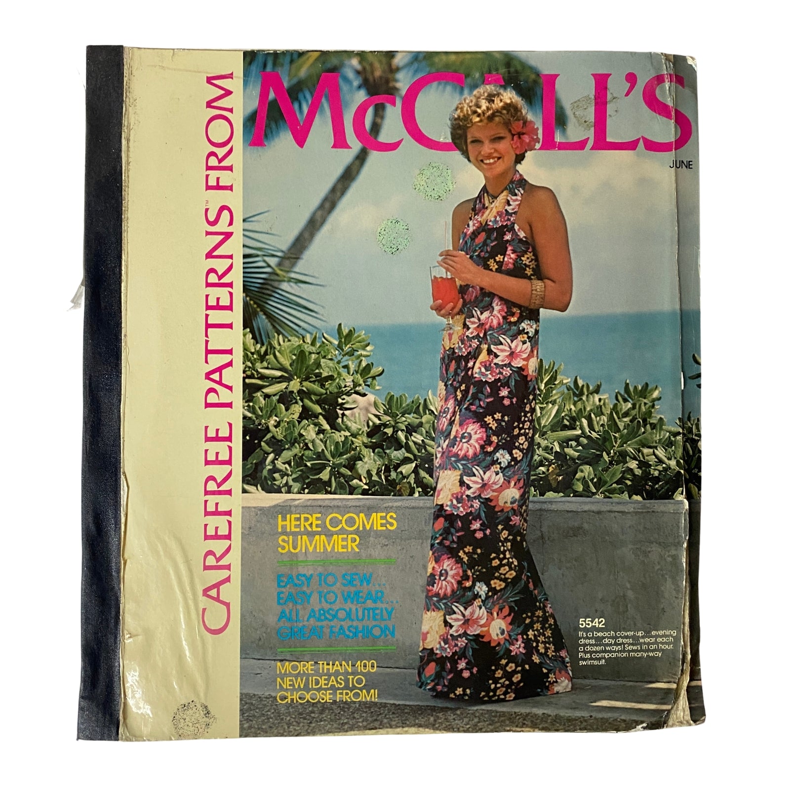 Cover of the 1970s June Carefree Patterns from McCall's Catalog featuring a model in a floral dress with a tropical background, inviting a summer fashion vibe.