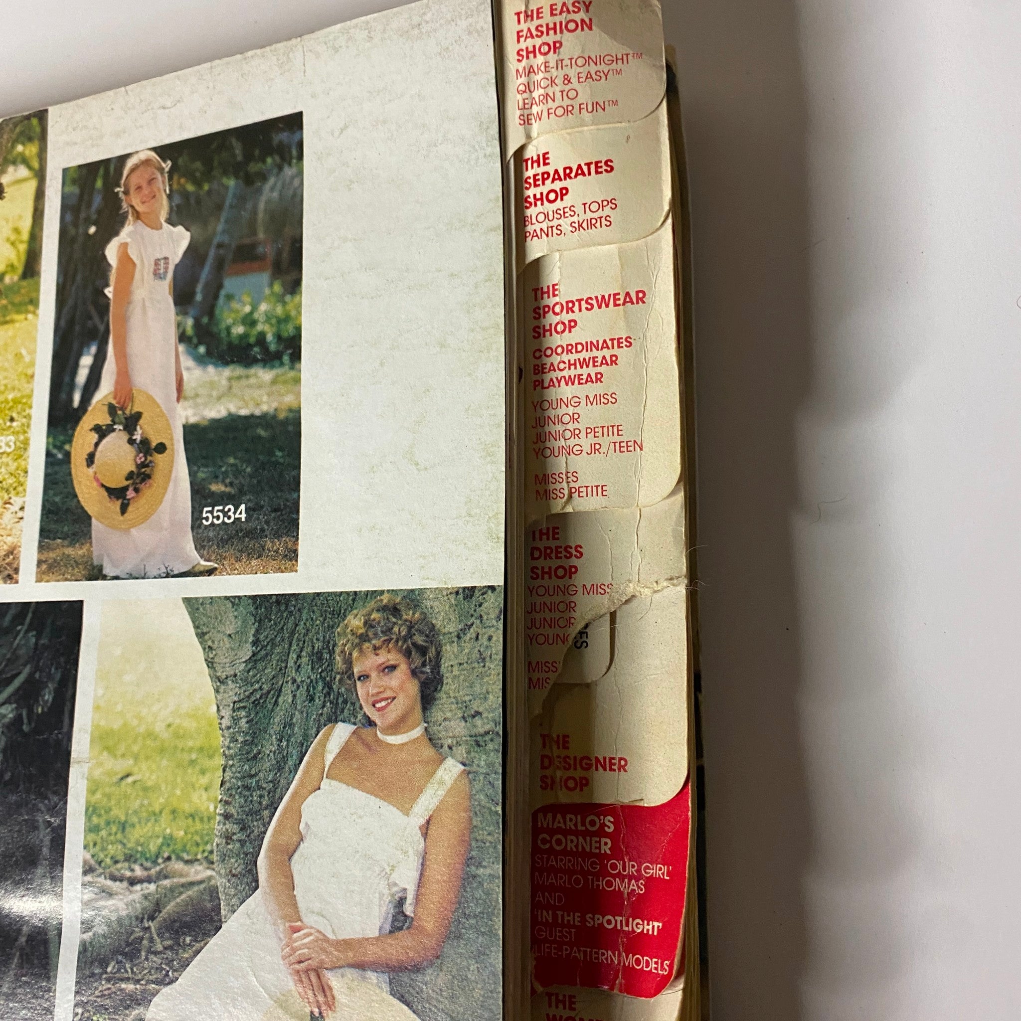 Interior page of the 1970s June Carefree Patterns from McCall's Catalog featuring two models in stylish summer dresses, showcasing various design options and fashion inspiration.