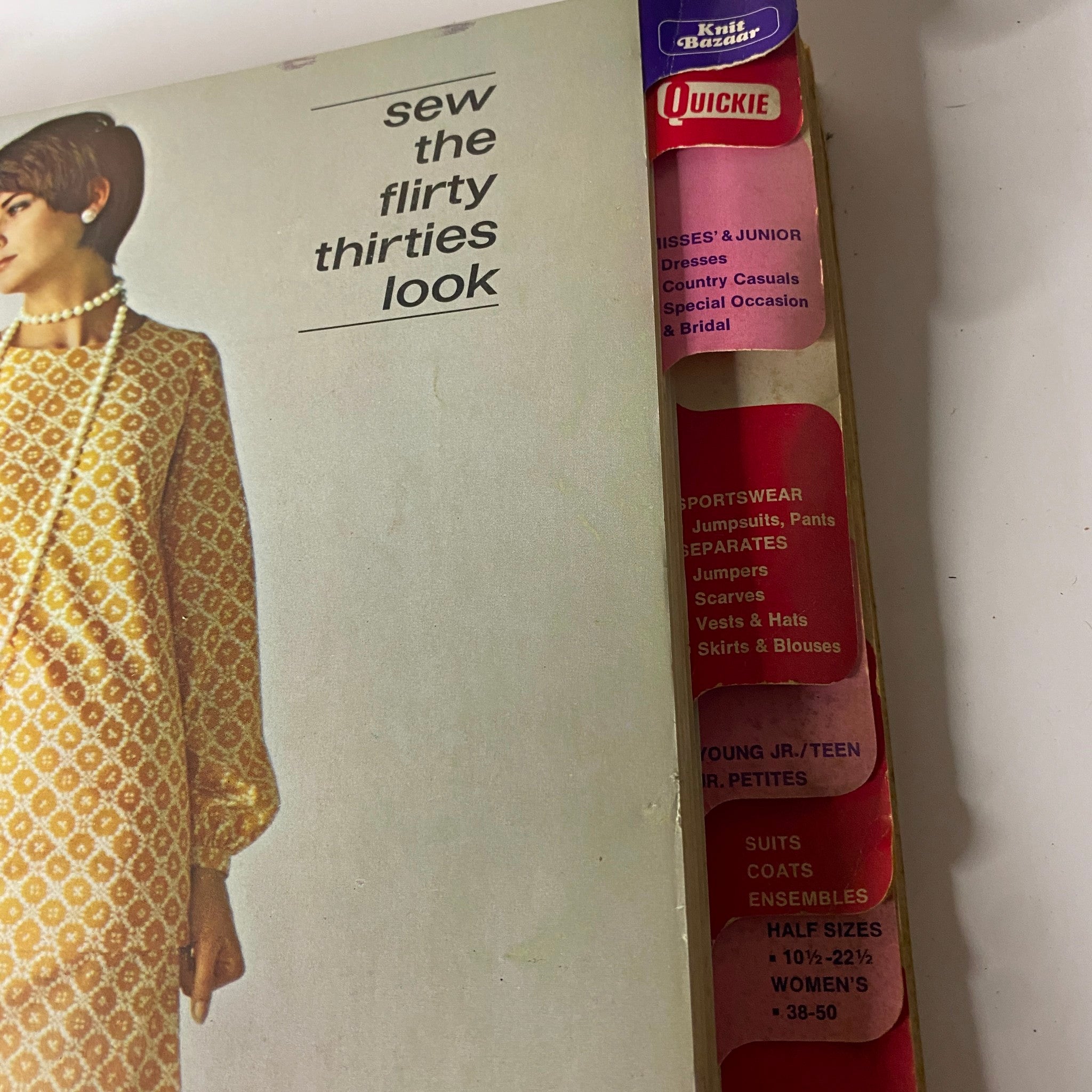 1960s April McCall's Step-by-Step Pattern Catalog cover showcasing a model in a stylish, flirty thirties dress with detailed tabs highlighting different sections.