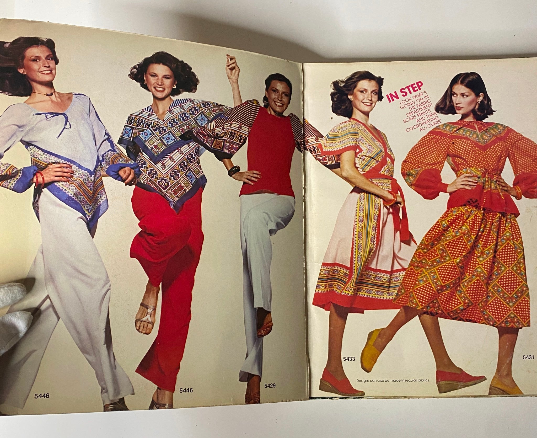Inside page of the 1970s March Carefree Patterns from McCall's Catalog showcasing models wearing colorful outfits including tops and dresses, highlighting 1970s fashion.