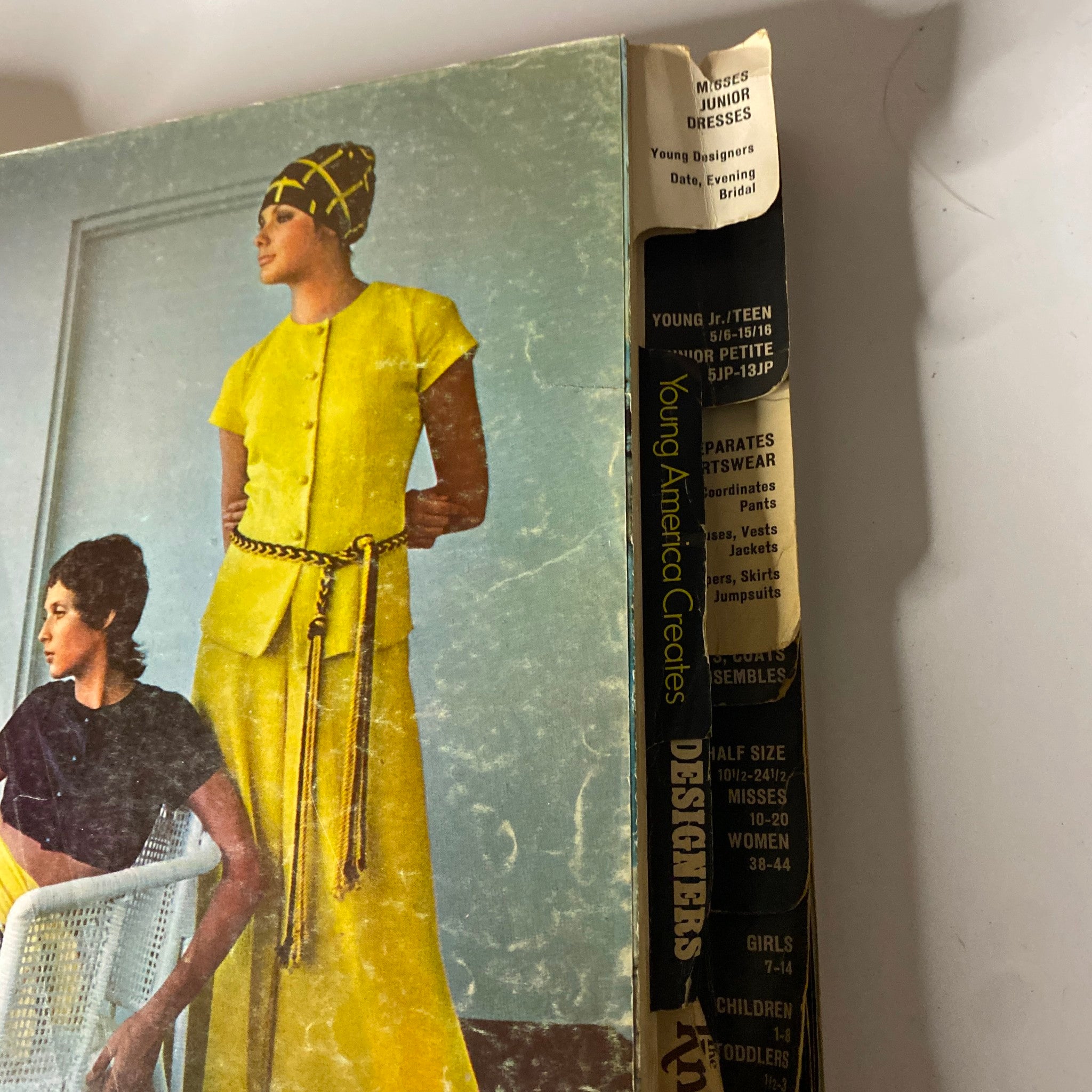 Close-up of the 1970 July Butterick Catalog spine with visible wear. The catalog includes patterns for misses and junior dresses designed for young fashionistas.
