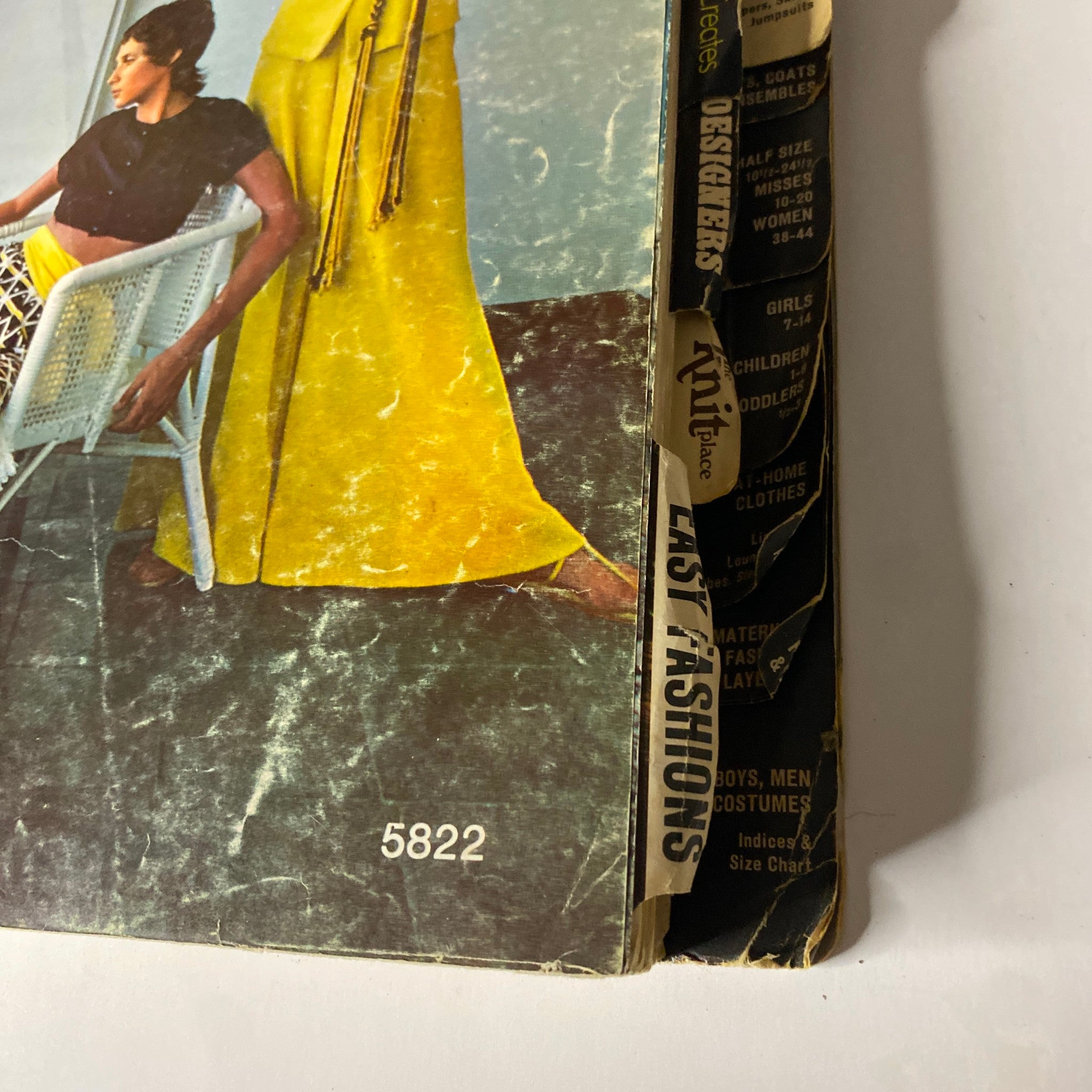 Detailed view of the back of the 1970 July Butterick Catalog showcasing vibrant fashion designs. This catalog contains a variety of sewing patterns for young designers.
