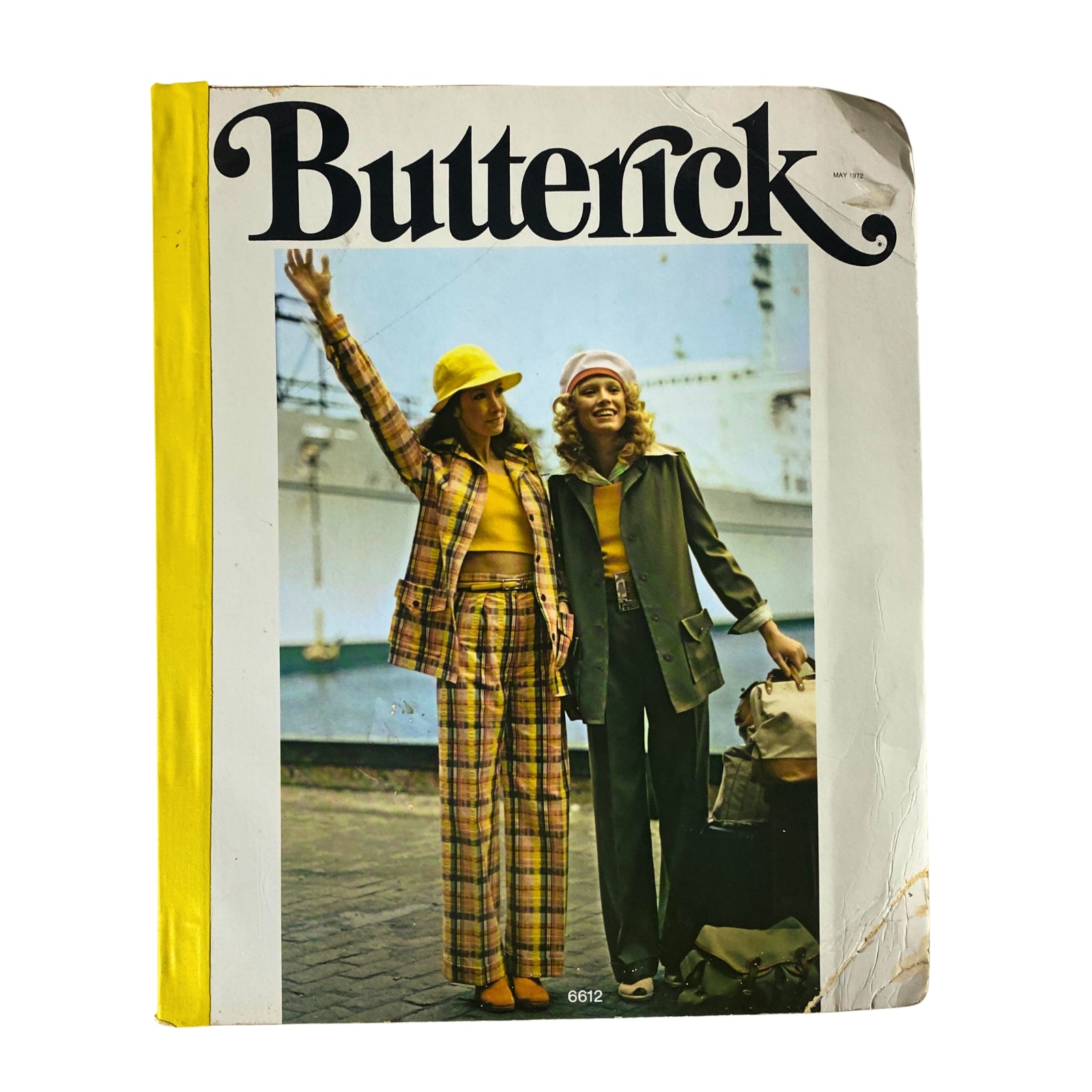 Cover of the 1972 May Butterick Catalog featuring stylish women's fashion, including two models wearing vibrant outfits and accessories, showcasing the essence of 1970s fashion.