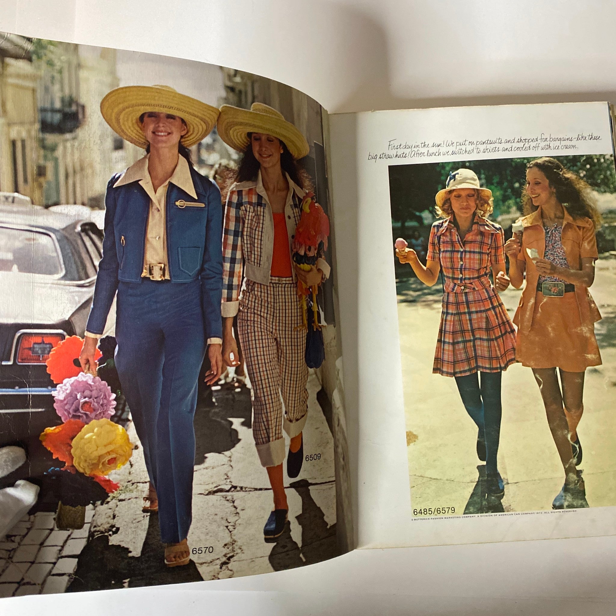 1972 May Butterick Catalog image displaying two women in fashionable outfits, walking on the street with large sun hats, embodying the trendy spirit of 1970s fashion.