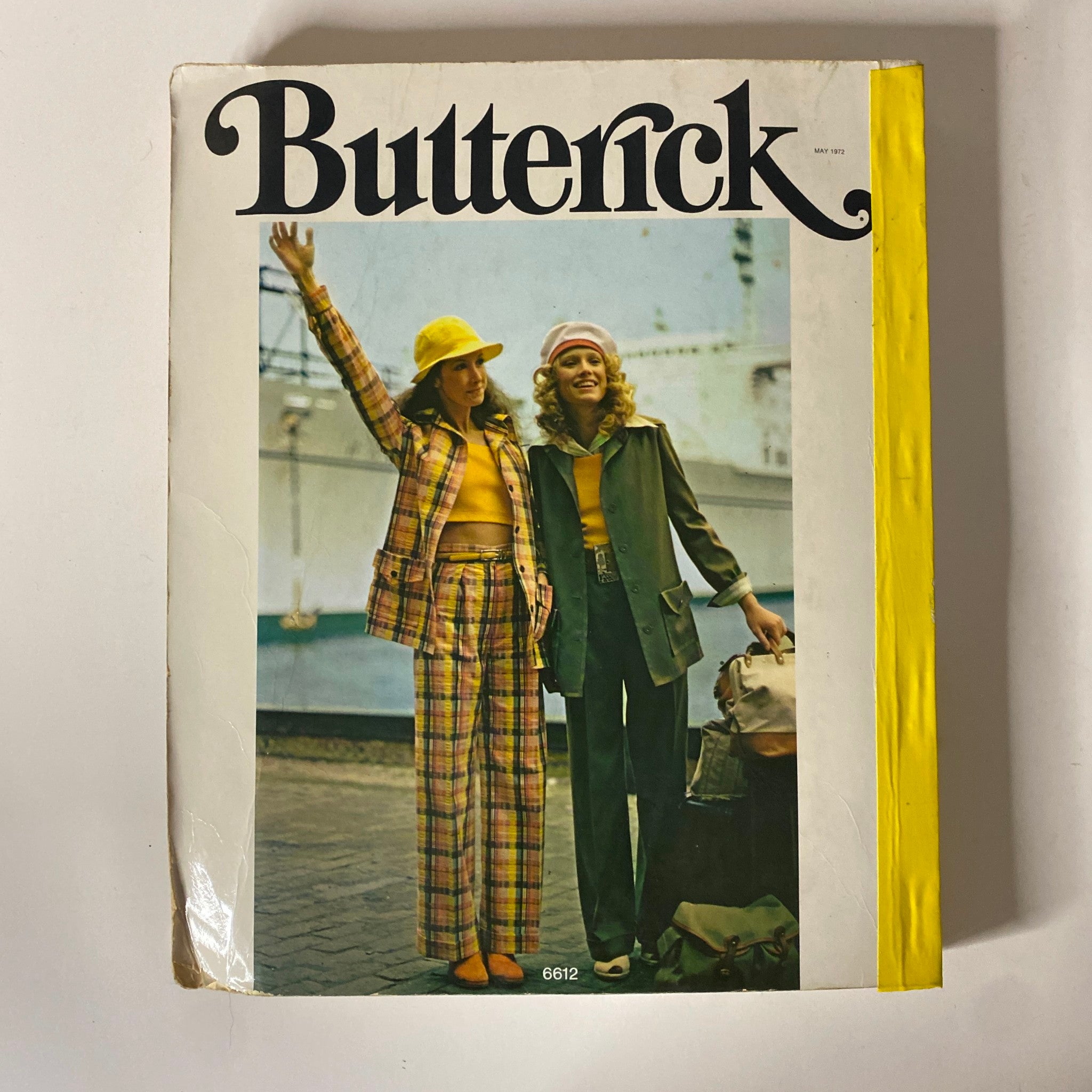 Cover of the 1972 May Butterick Catalog presenting two stylish women in vintage outfits, showcasing the essence of 1970s fashion and sewing patterns.