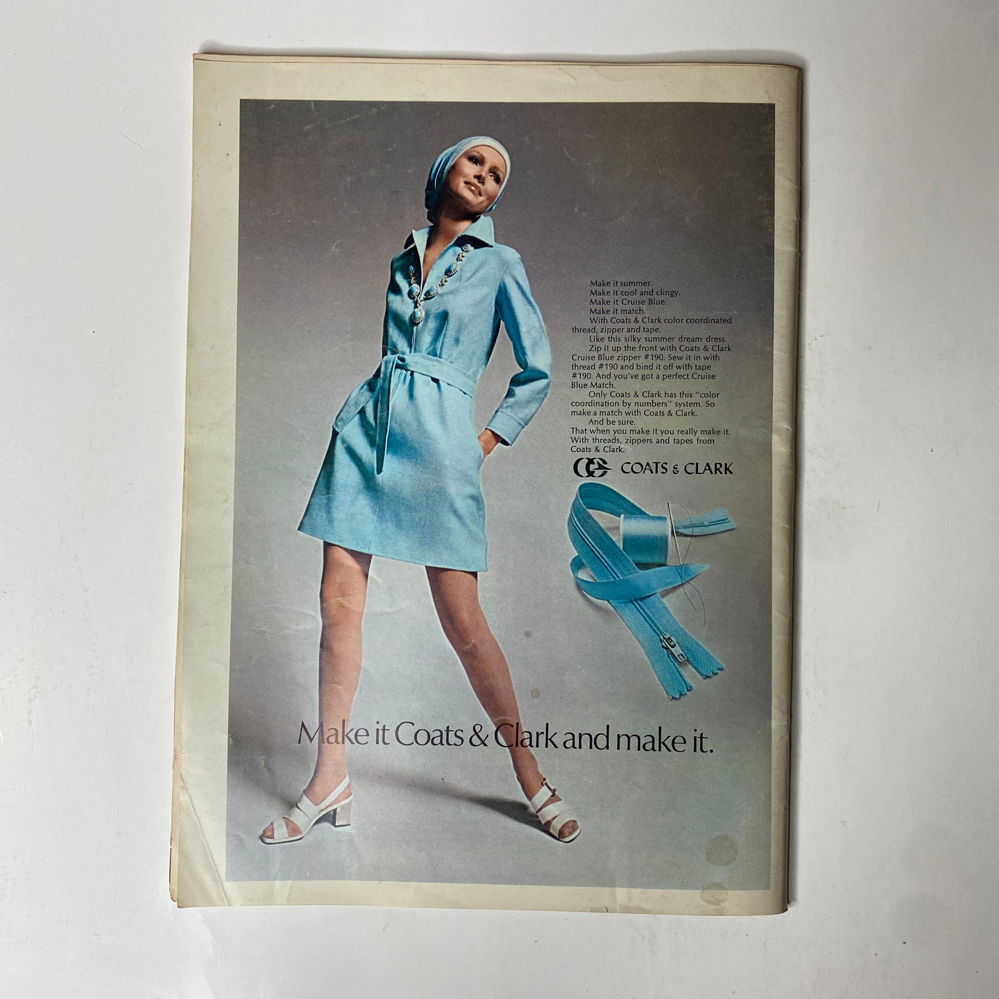 1970 Butterick Summer Home Catalog featuring a model in a light blue dress with a tie belt and matching headscarf, showcasing a Coats & Clark advertisement for summer sewing patterns.