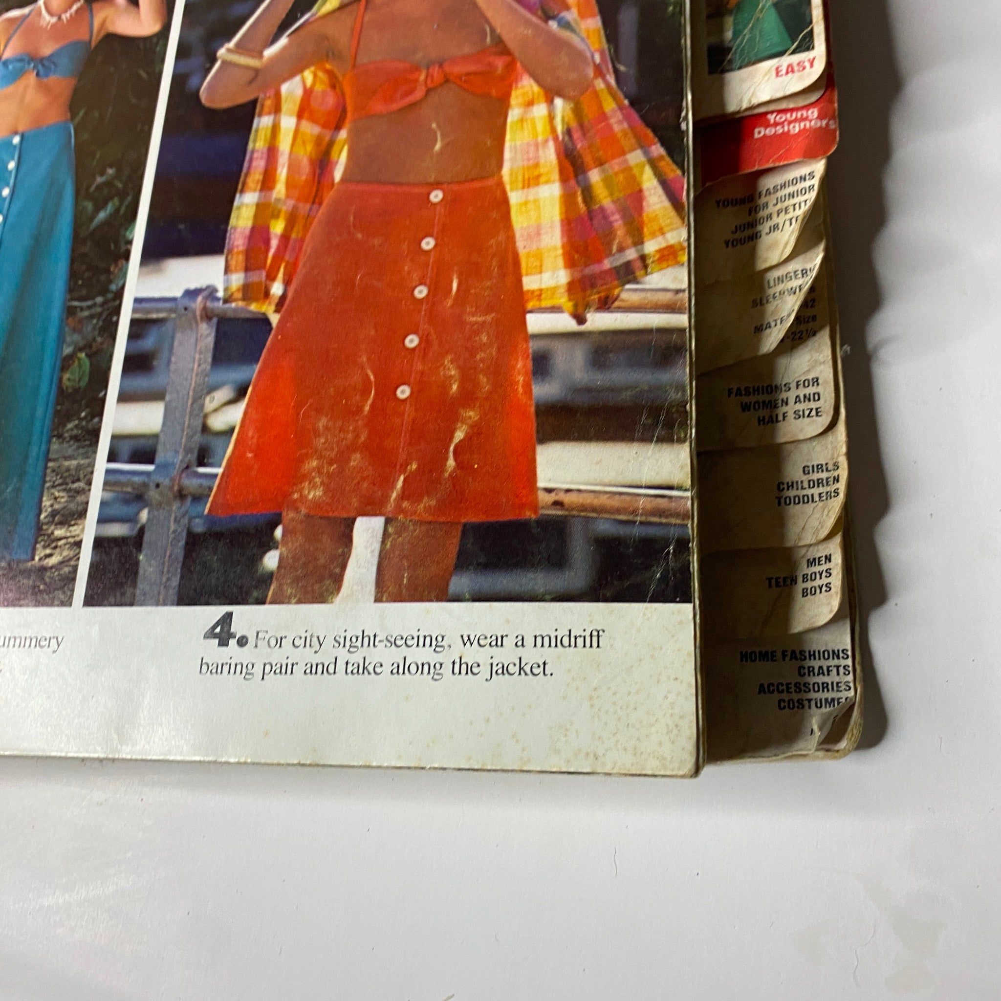 Close-up view of the back cover of the 1974 June Butterick Catalog, featuring model photographs and styling suggestions. Highlights fashion tips for casual and summer wear with vibrant patterns and practical layering for contemporary looks.