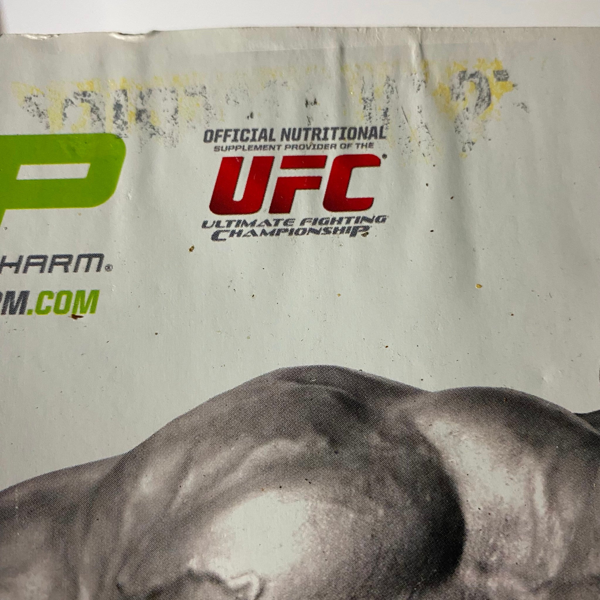 Close-up detail of Muscular Development Magazine January 2012 Victor Martinez Cover featuring the UFC logo and nutritional supplement branding, with slight marks visible.