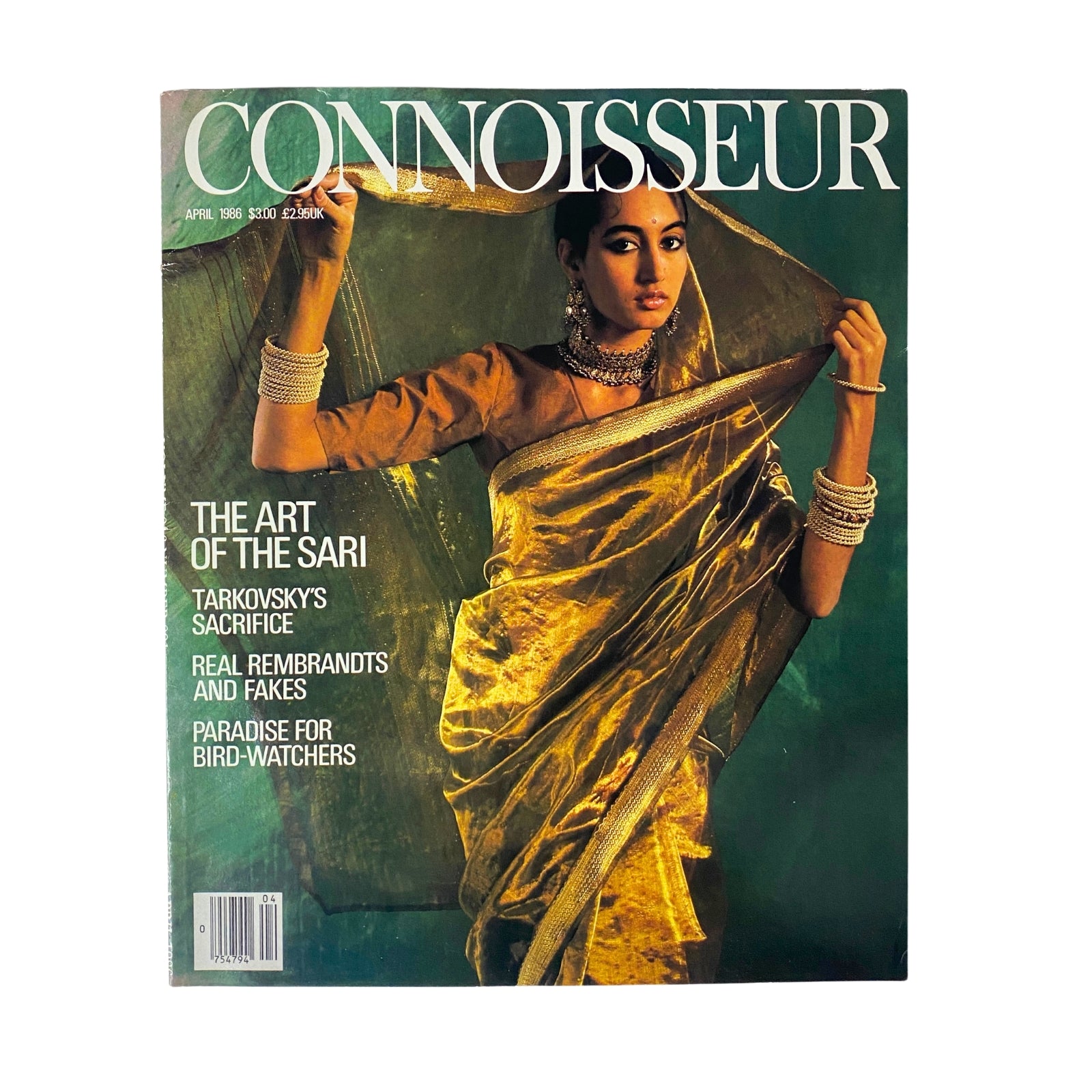 Connoisseur Magazine April 1986 cover featuring 'The Art of The Sari', showcasing a model in a golden sari, highlighting elegance and cultural fashion.