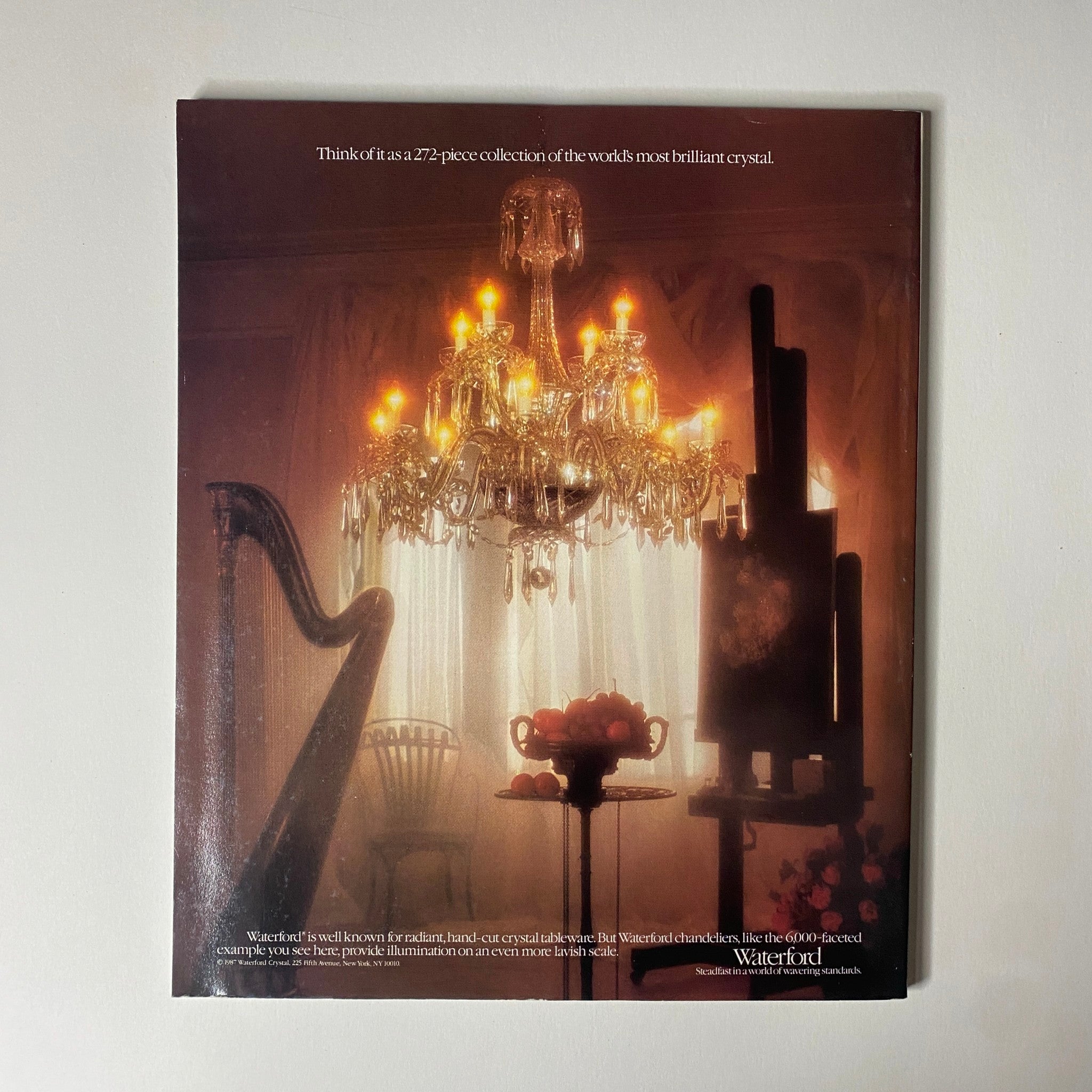 Connoisseur Magazine September 1987 back cover displays a warm-lit interior featuring a Waterford crystal chandelier, advertising a 272-piece crystal collection, enhancing the theme of luxury and fine living.